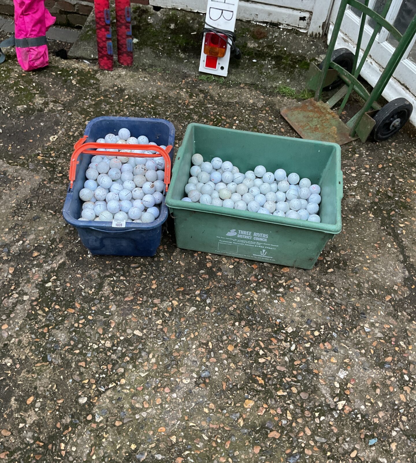 Two tubs of mixed golf balls