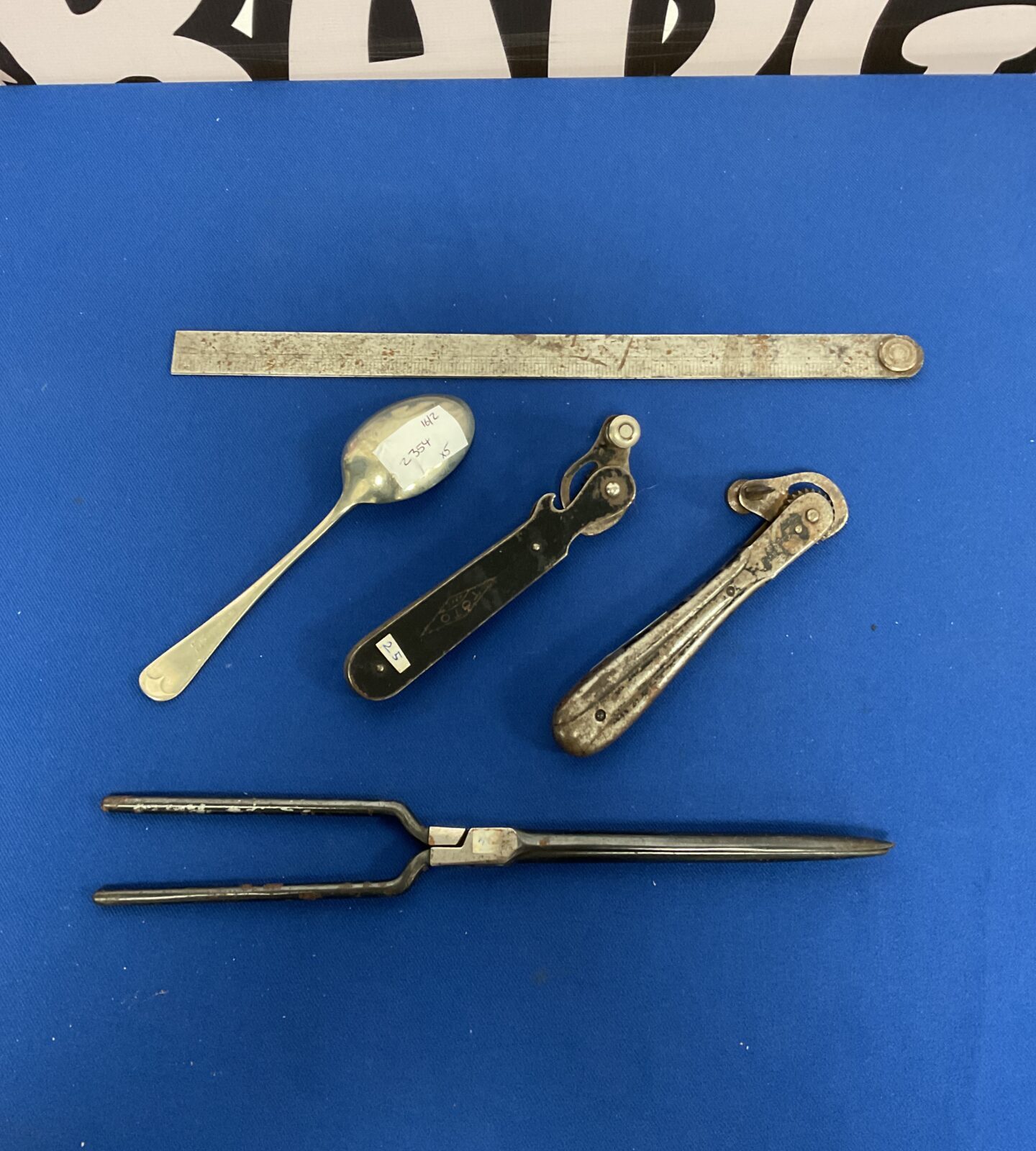 Two vintage can openers, glove stretcher & military marked spoon