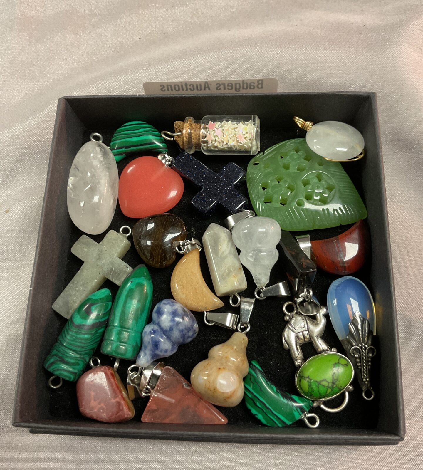 Tray of stone and crystal pendants