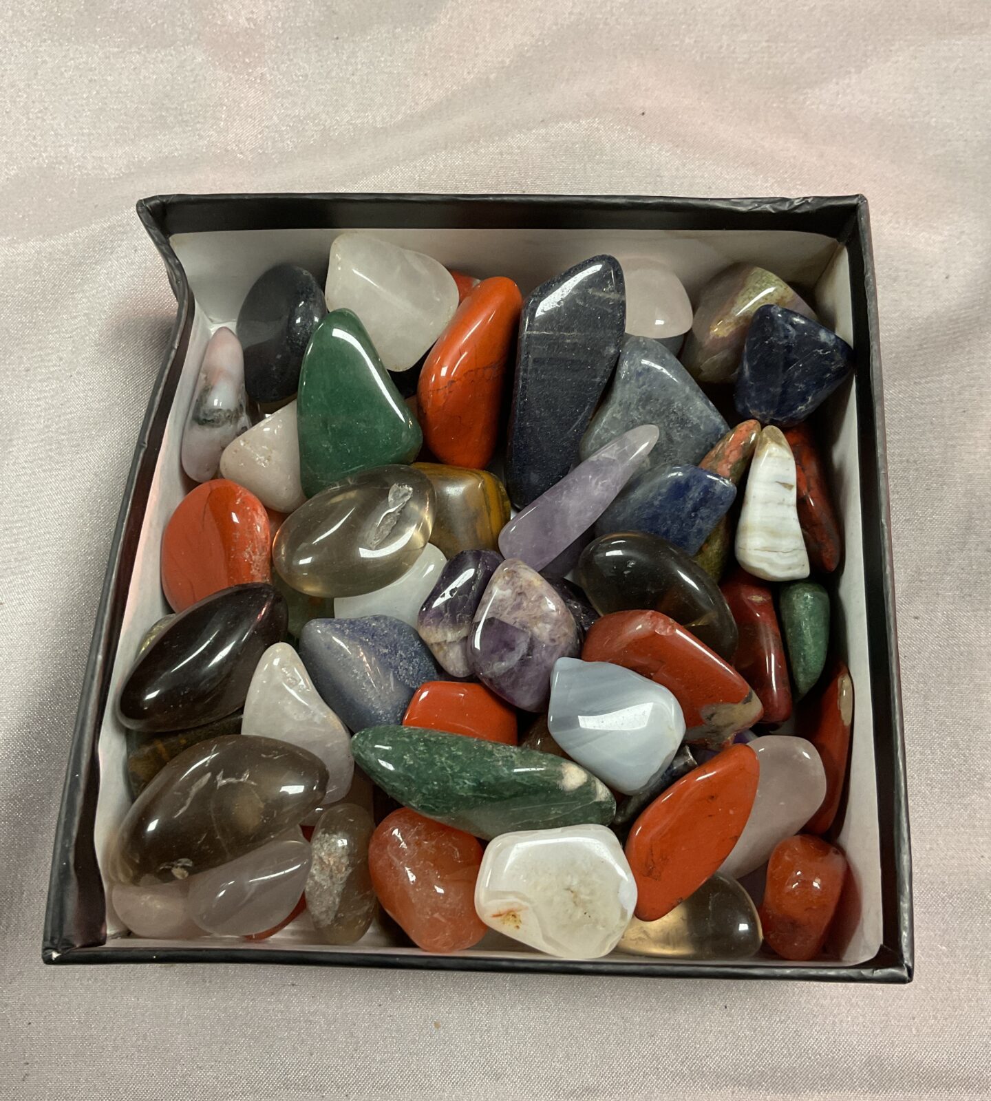 Box of polished stones and crystals