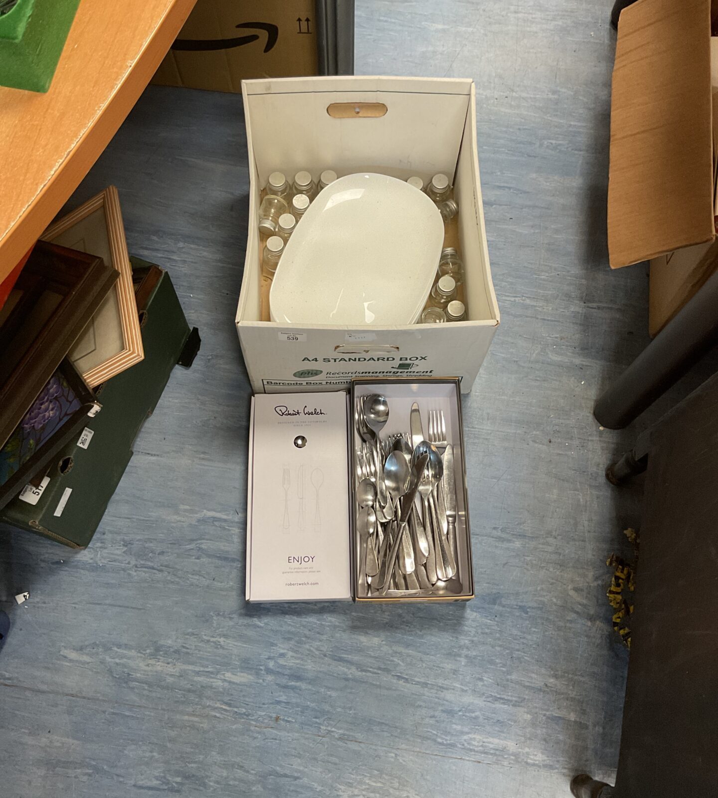 Box of mixed kitchenware inc large serving dishes, selection of cutlery and small glass storage bottles