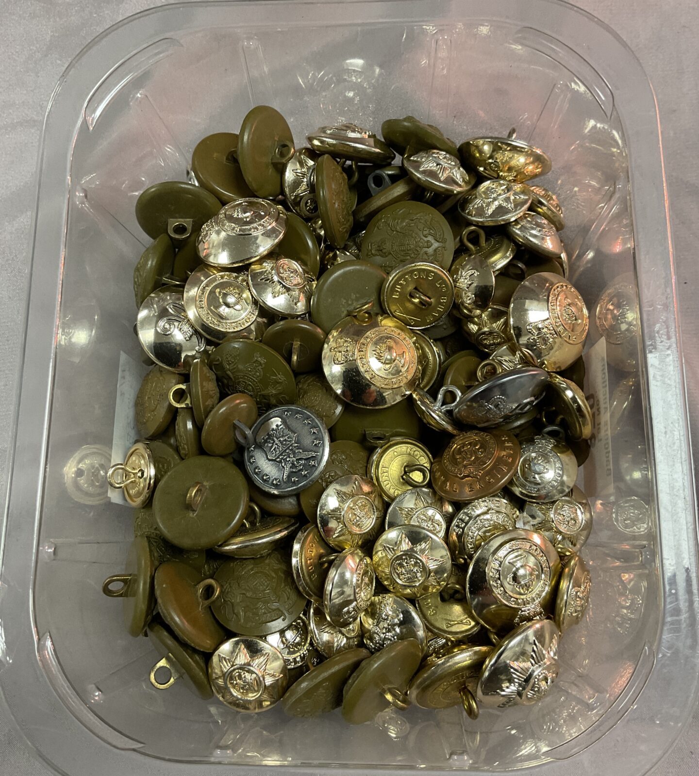 Tub of assorted military buttons