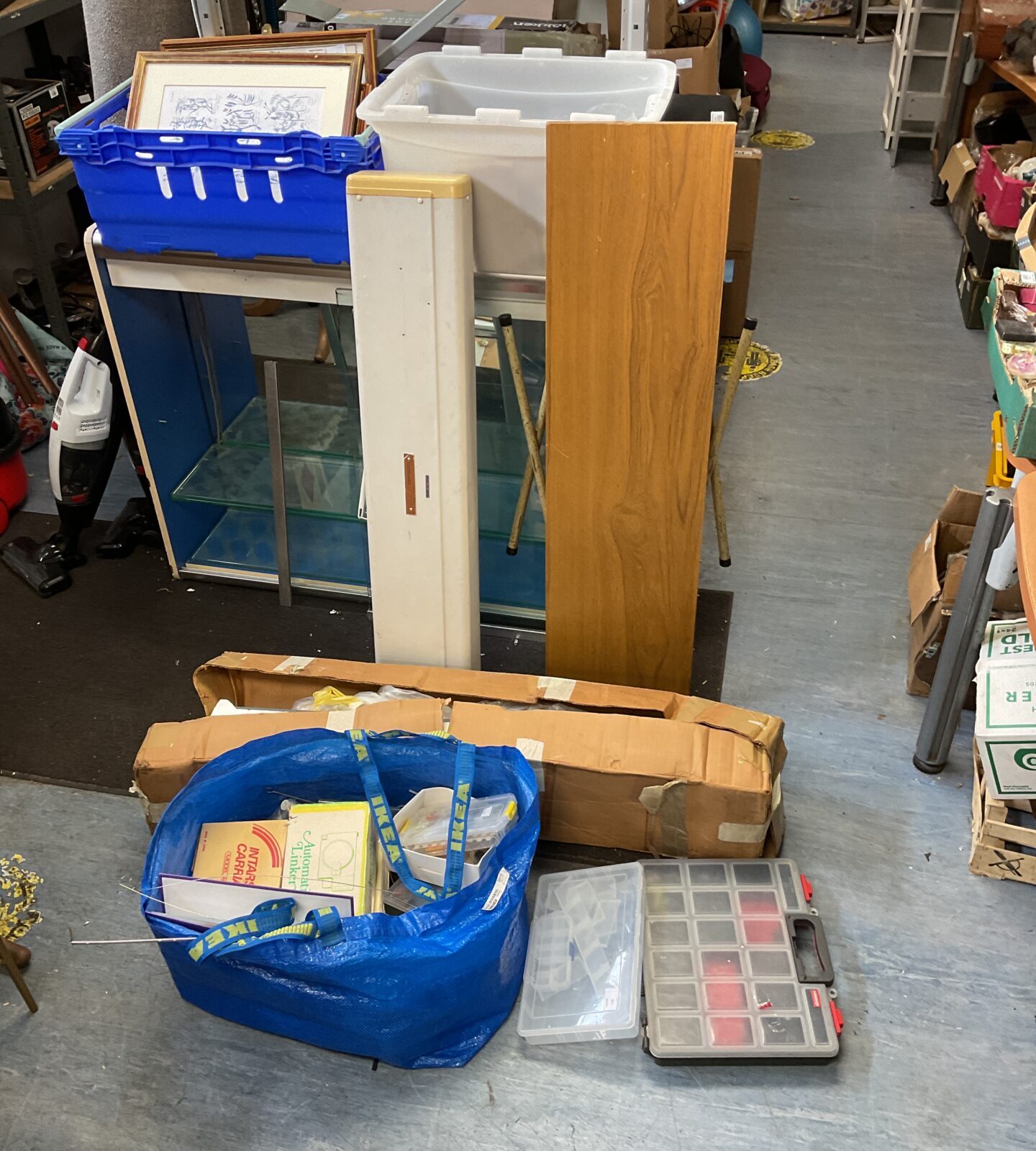 Two knitting machines, table & large sack of accessories