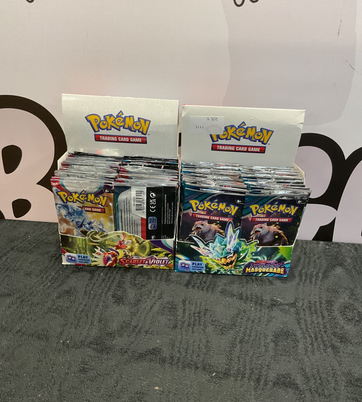 Two boxes of pokemon scarlet and violet booster packs opened