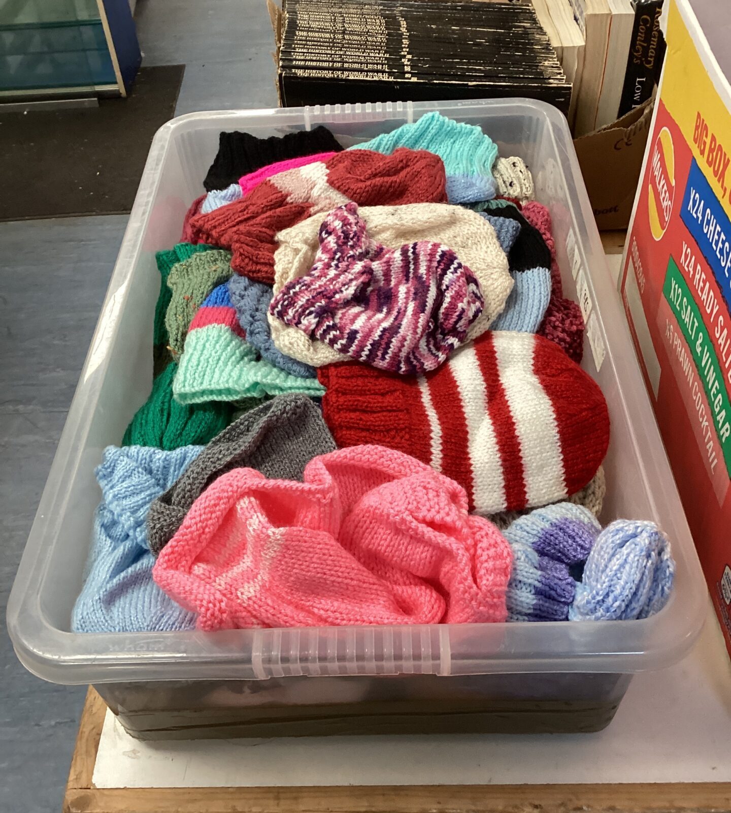 Box of hand knitted bobble hats