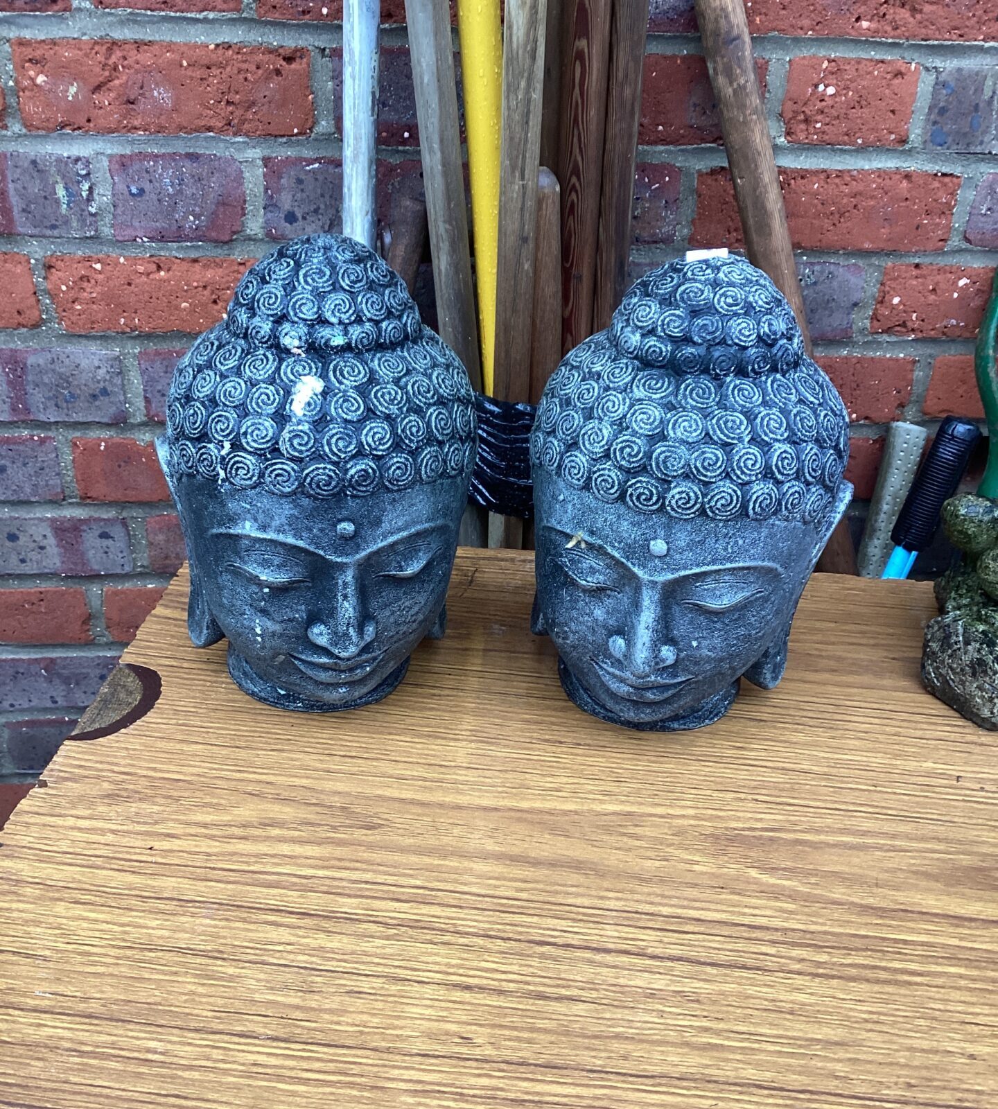 Two garden Buddha Head ornaments