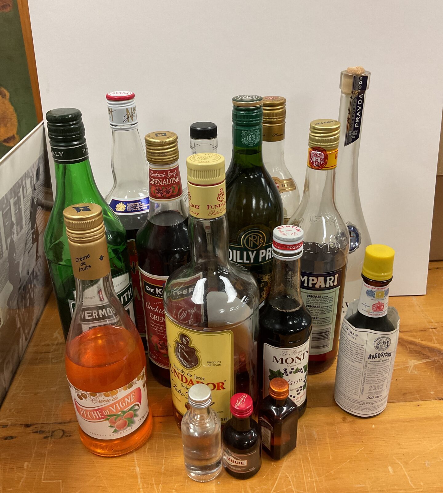 Large lot of part drunk bottles of alcohol including pravda vodka & fundador brandy