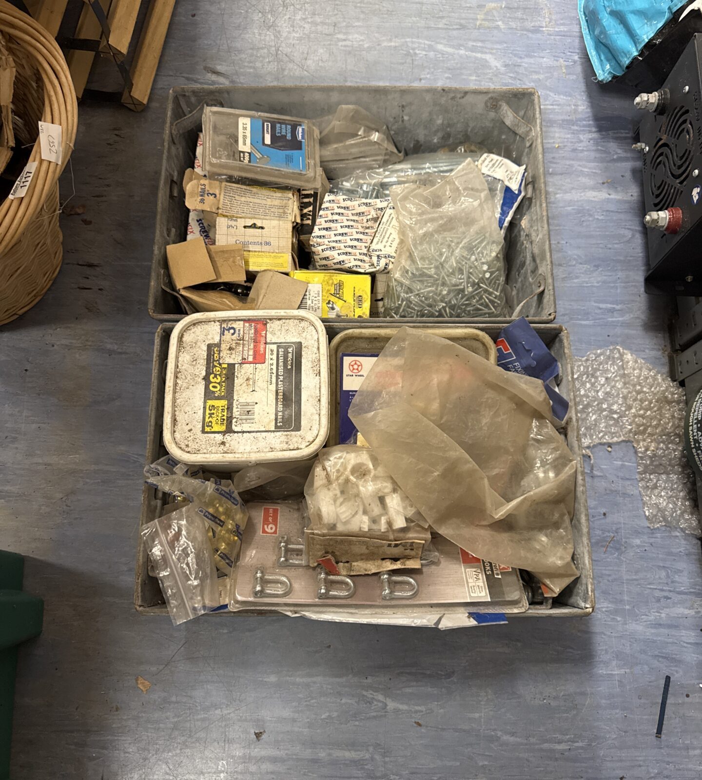 Two metal tote trays with shed clearance contents