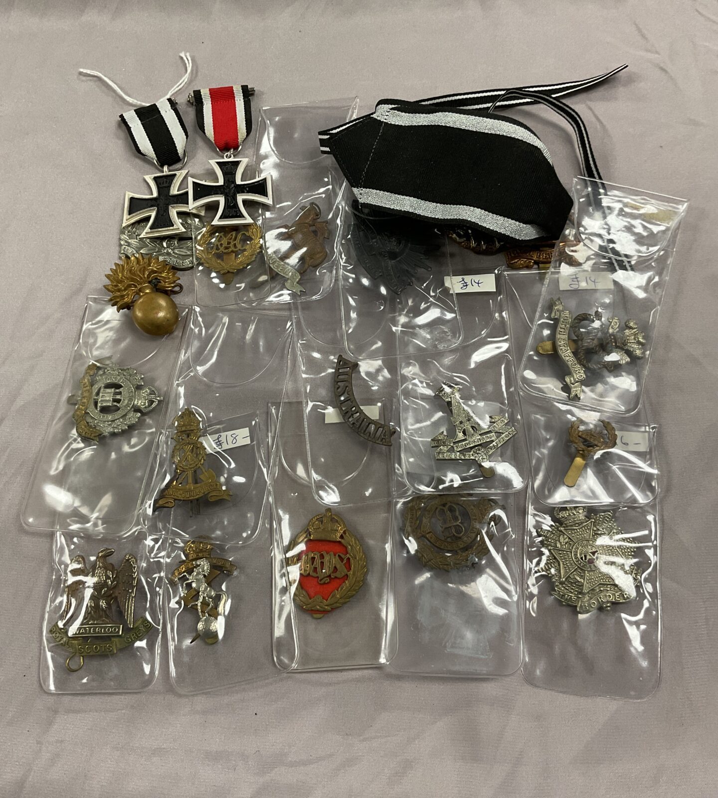 Collection of assorted British military cap badges and two German repro iron crosses