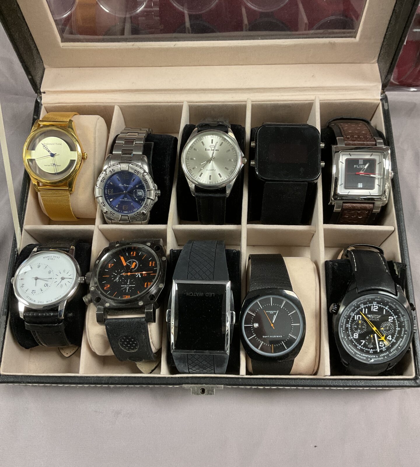 ten watches in display box and coin tra