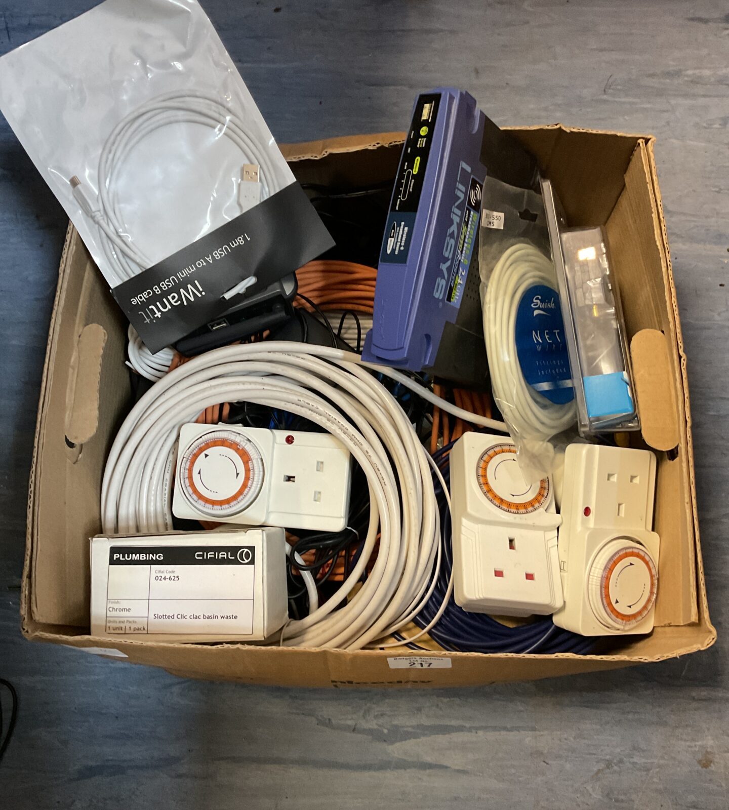 Box of pug socket timers, linkysys router & cables