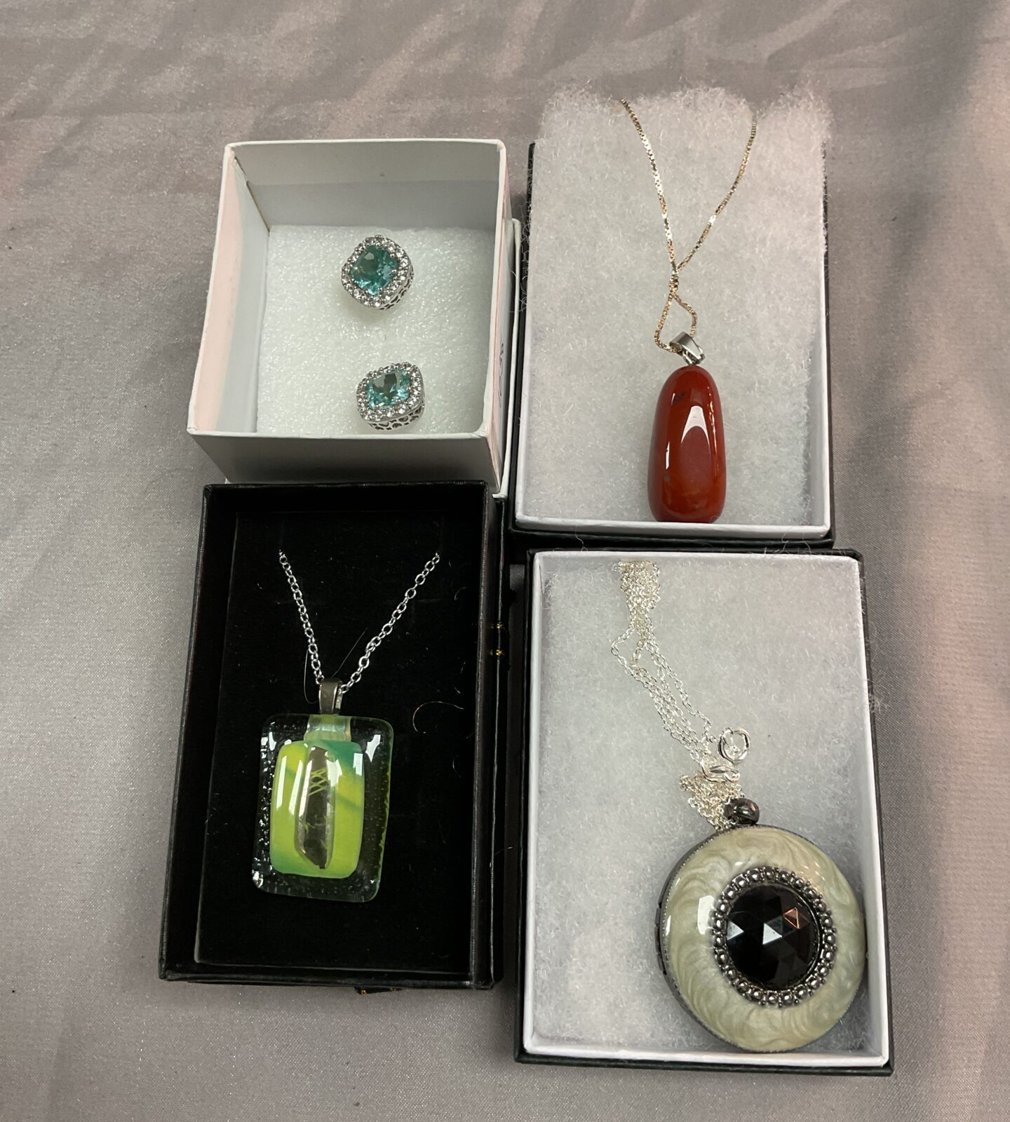 Three 925 Silver necklaces with stone pendants and a pair of earrings