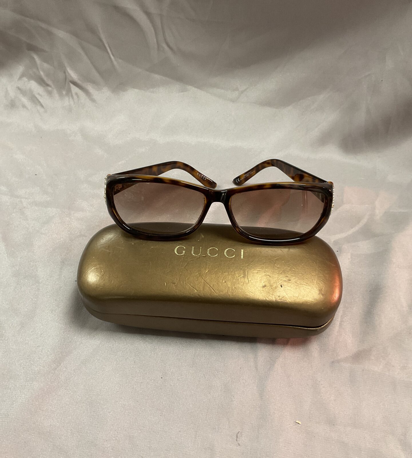 Pair of Gucci style sunglasses in case