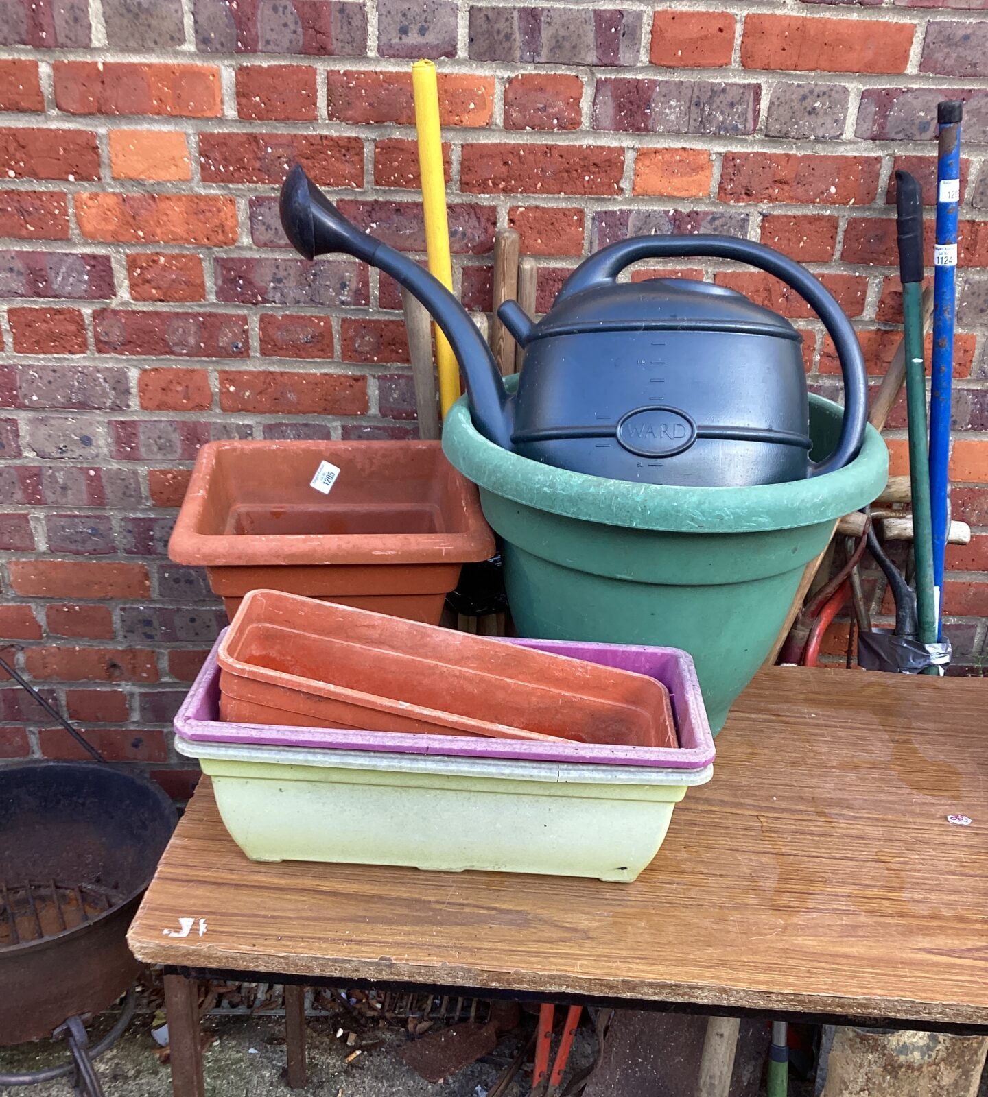 Plastic garden planters and watering can