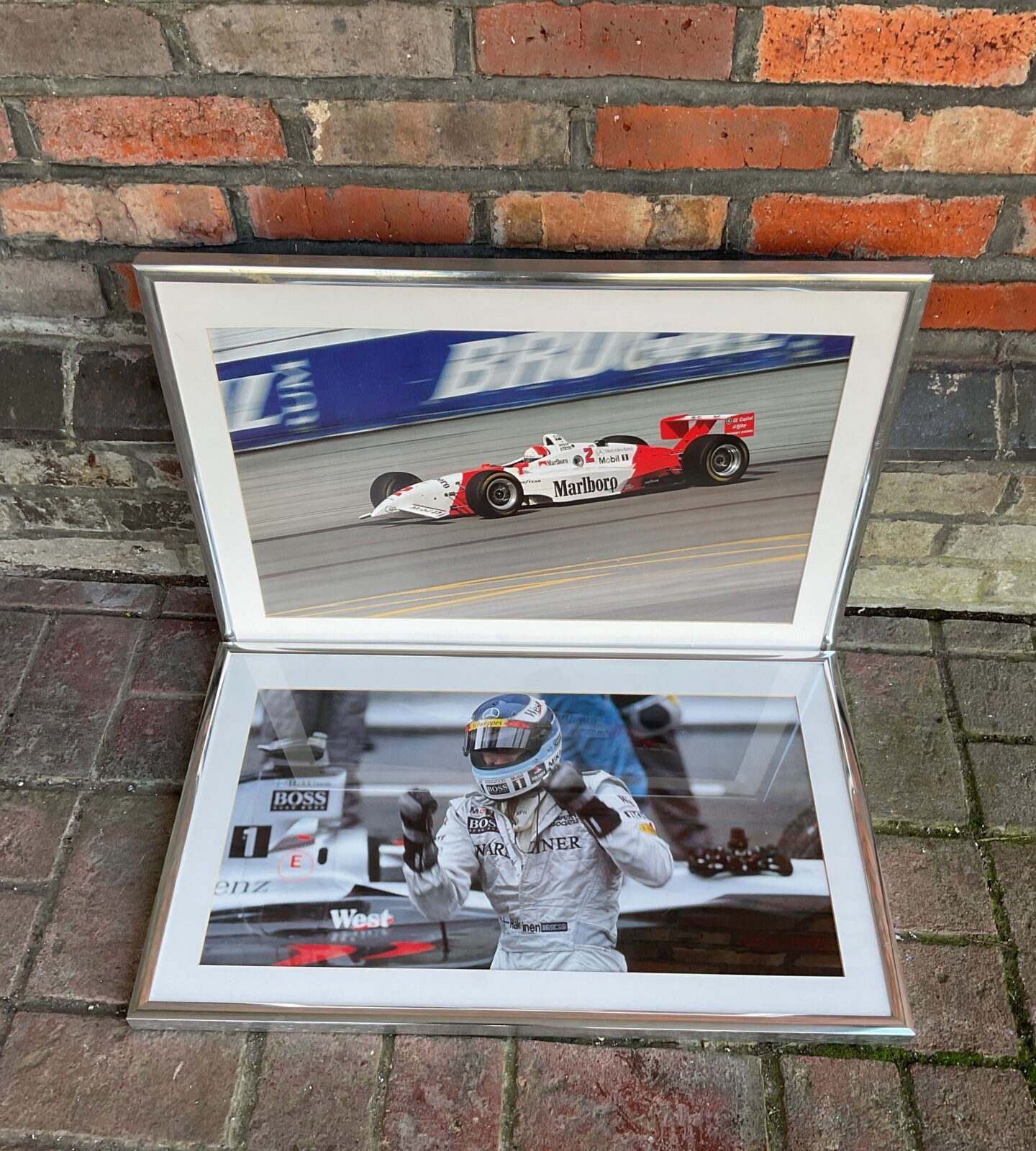 Two framed formula one racing prints including marlbro maclaren & hakinen