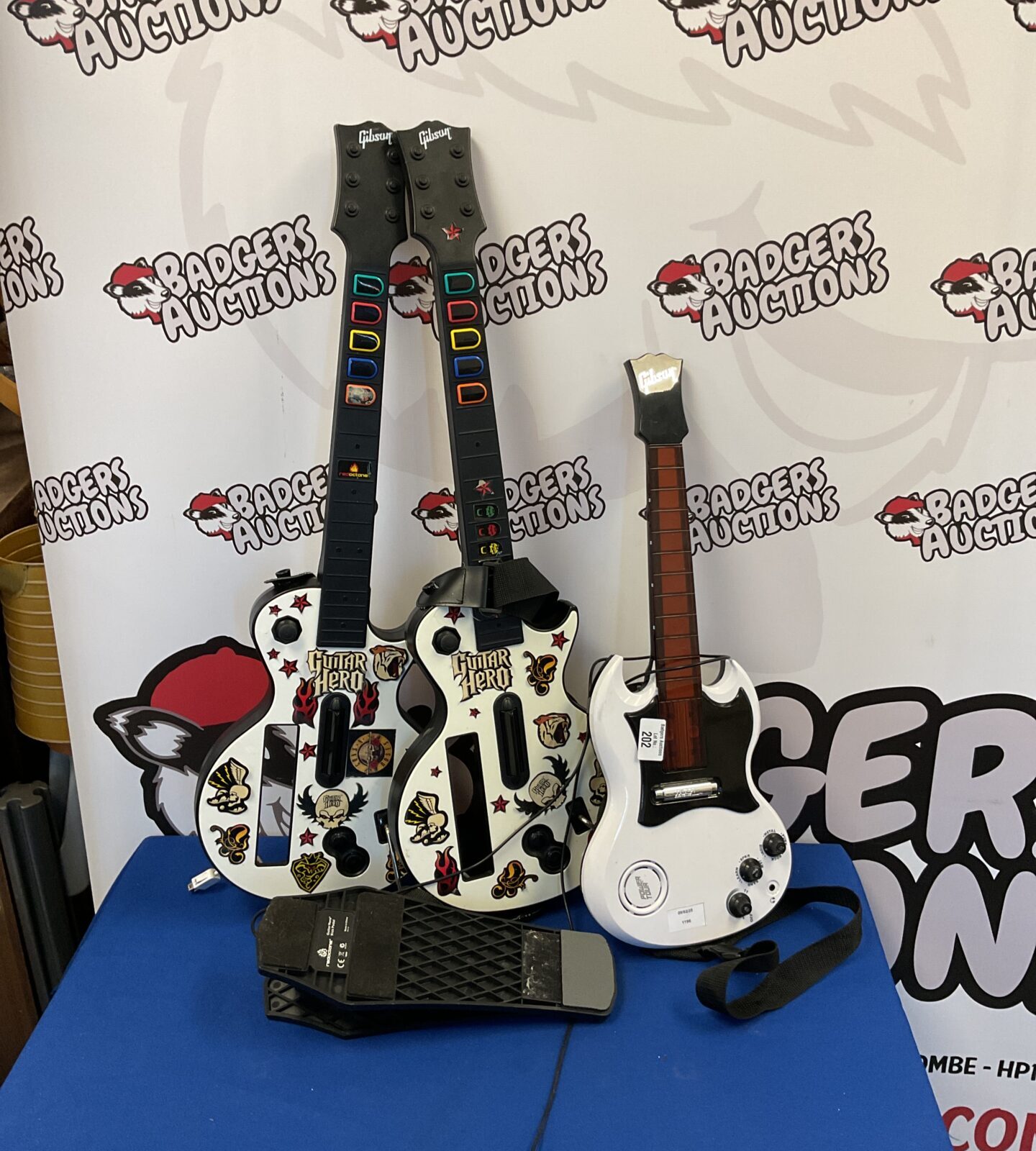 Two Nintendo wii guitar hero controllers & other toy guitar