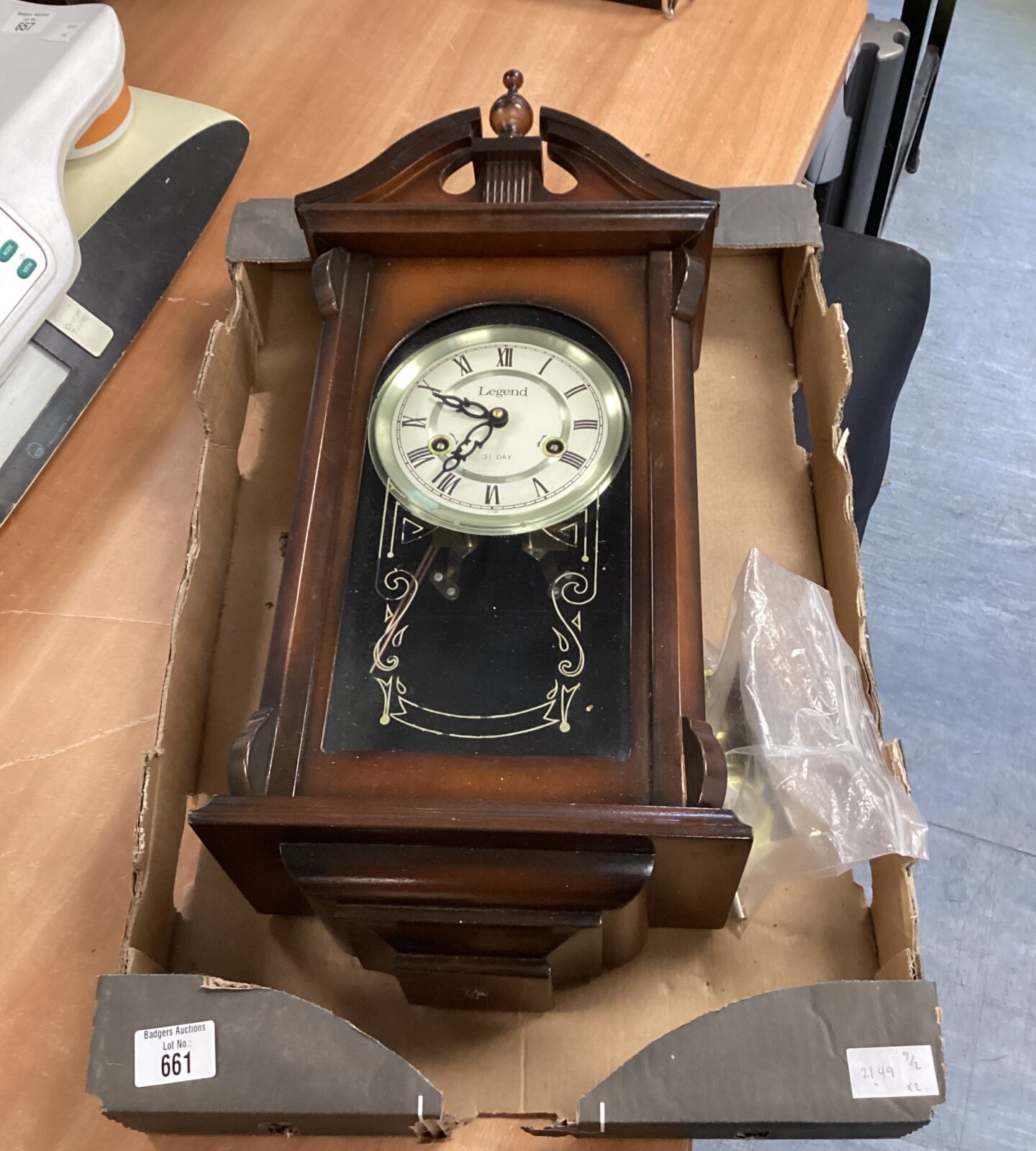 Legend wall clock with pendulum