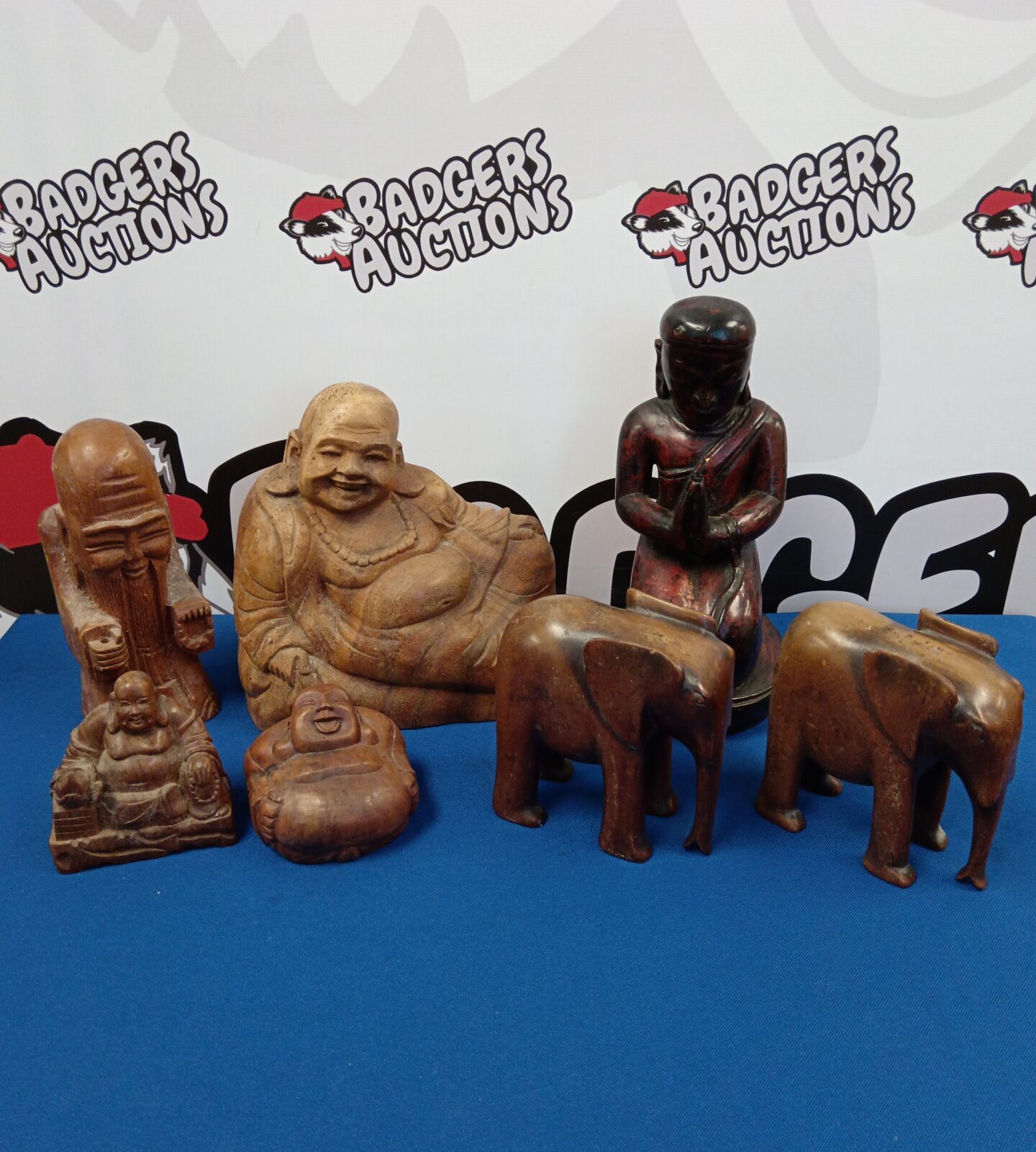Collection of carved wooden Buddhas & elephants