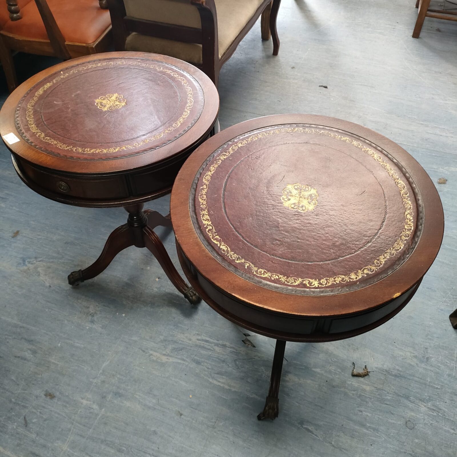 Two vintage red leather topped side tables with drawers