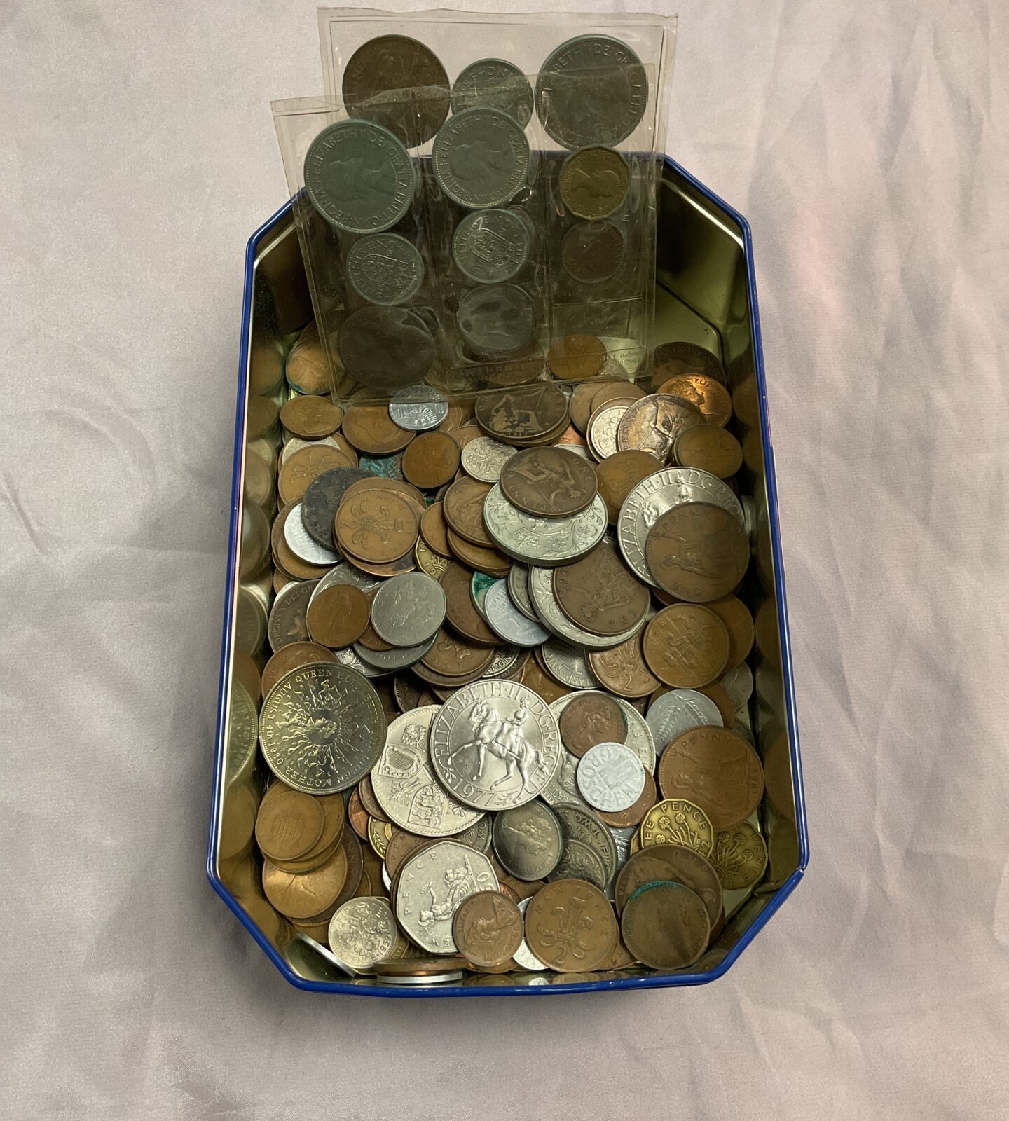 Tin of assorted coins