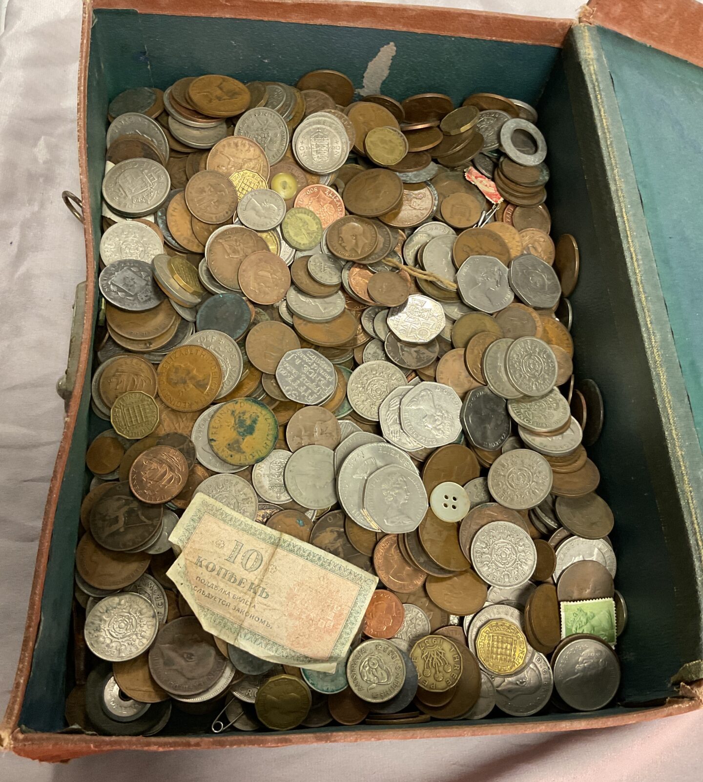 Old suitcase of assorted coins