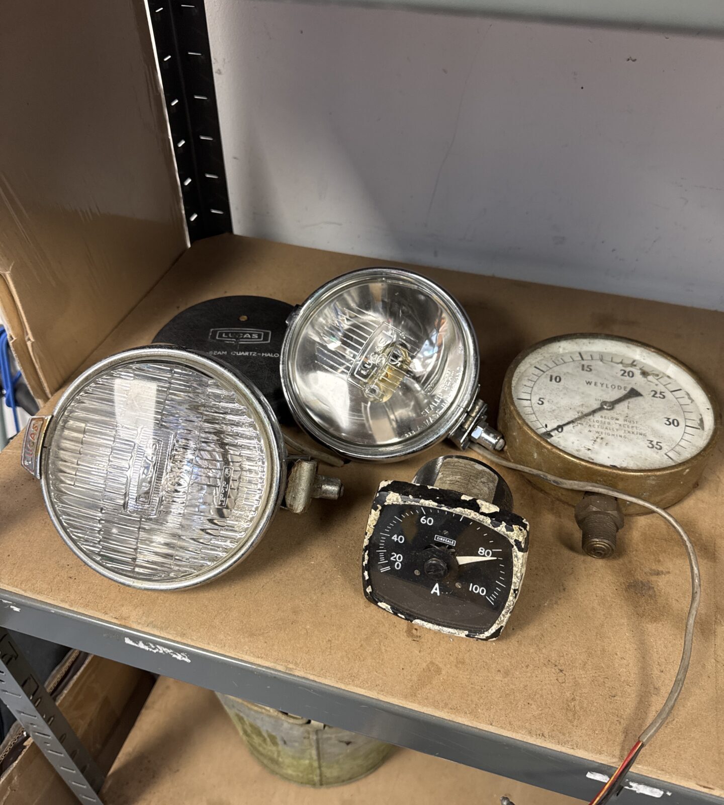 Two vintage gauges with two Lucas spot lamps (lamps not matching pair)