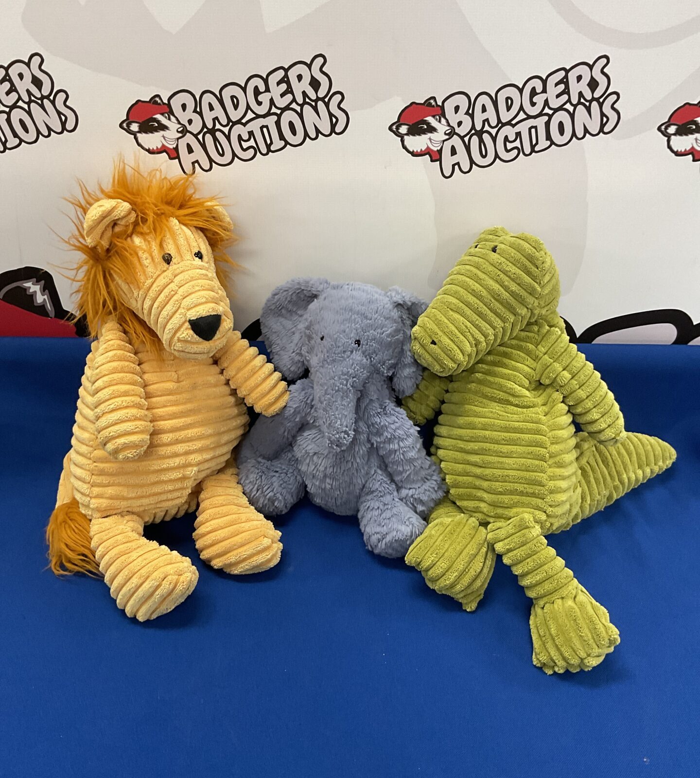 Three jellycat soft toys lion elephant and dragon