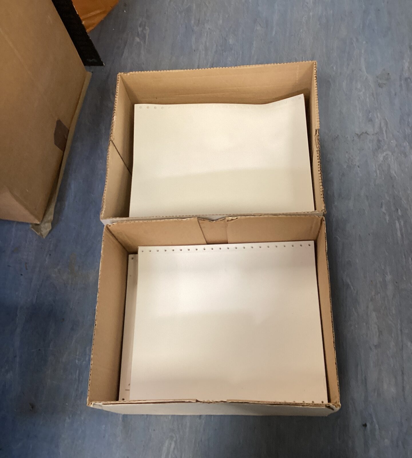 Two boxes of dot matrix printer paper