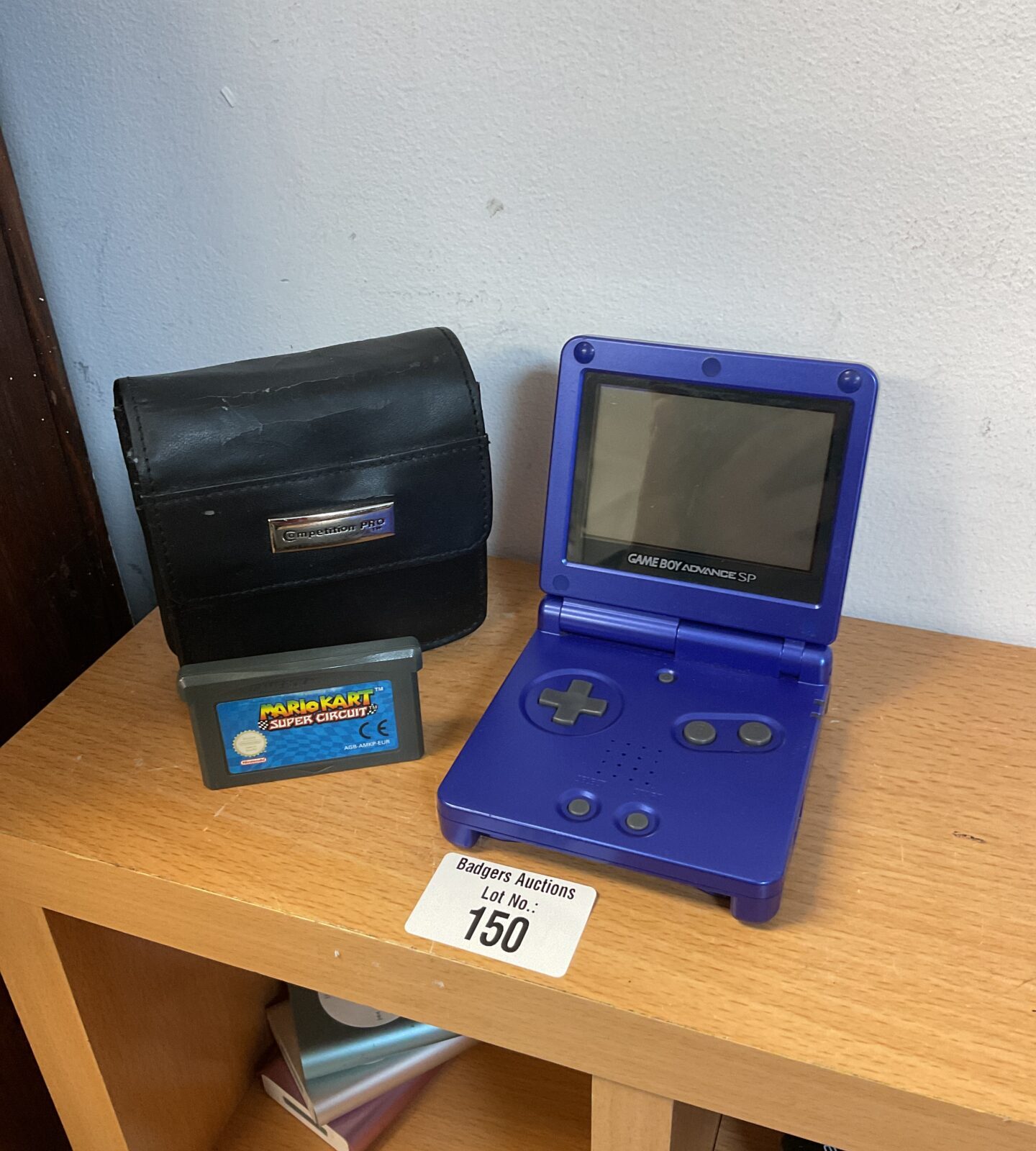 Blue nintendo gameboy advance sp with mario kart