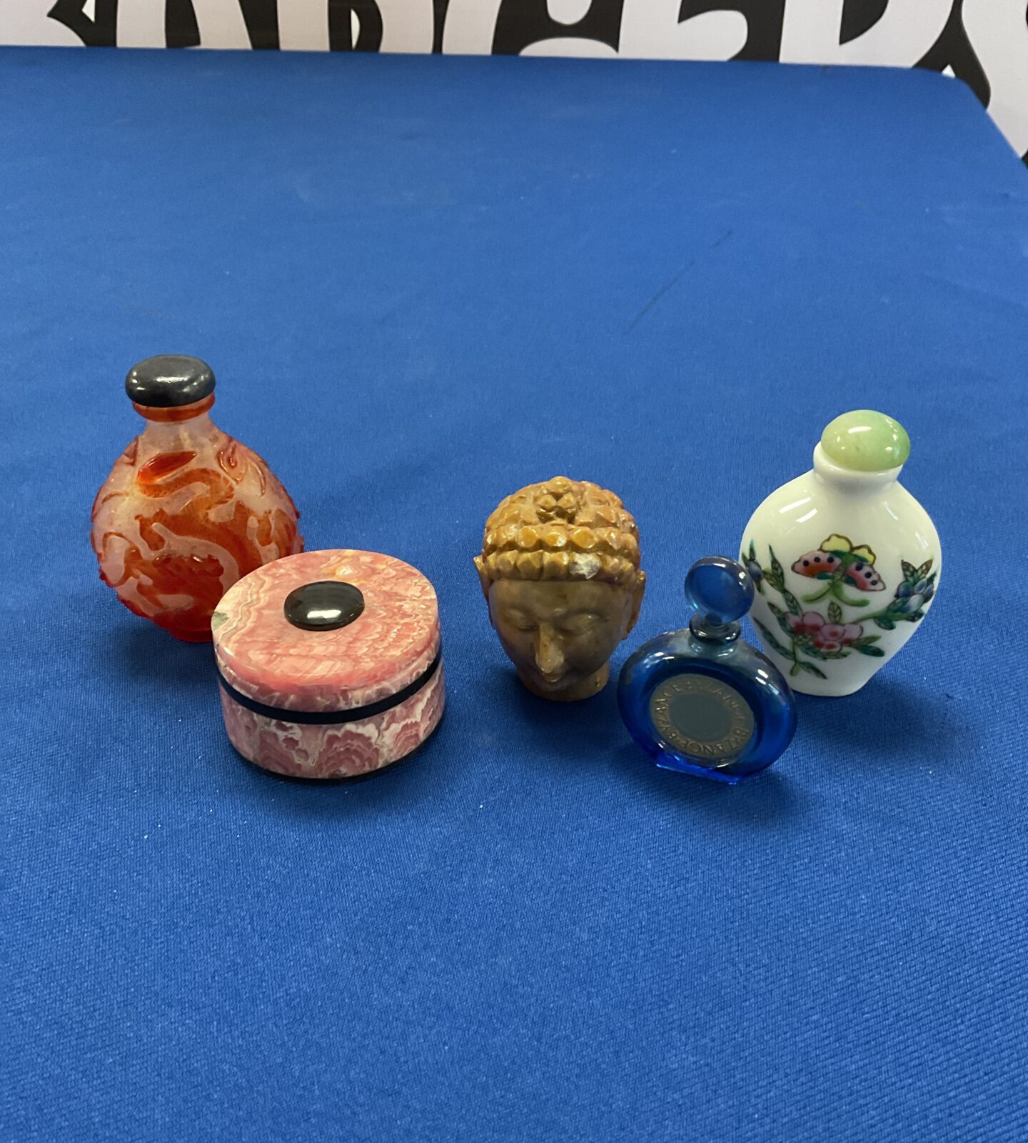 Three oriental scent bottles & stone buddha head & pot