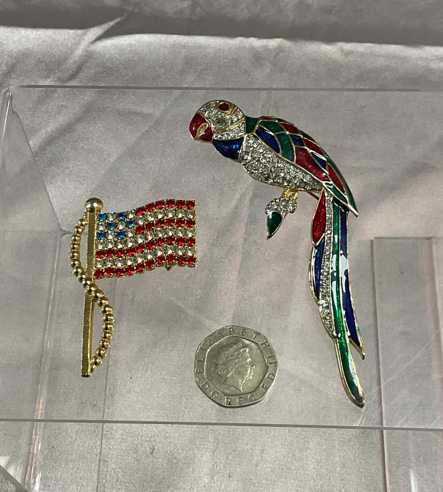 Stars and Stripes jewelled flag brooch and enamelled parrot brooch