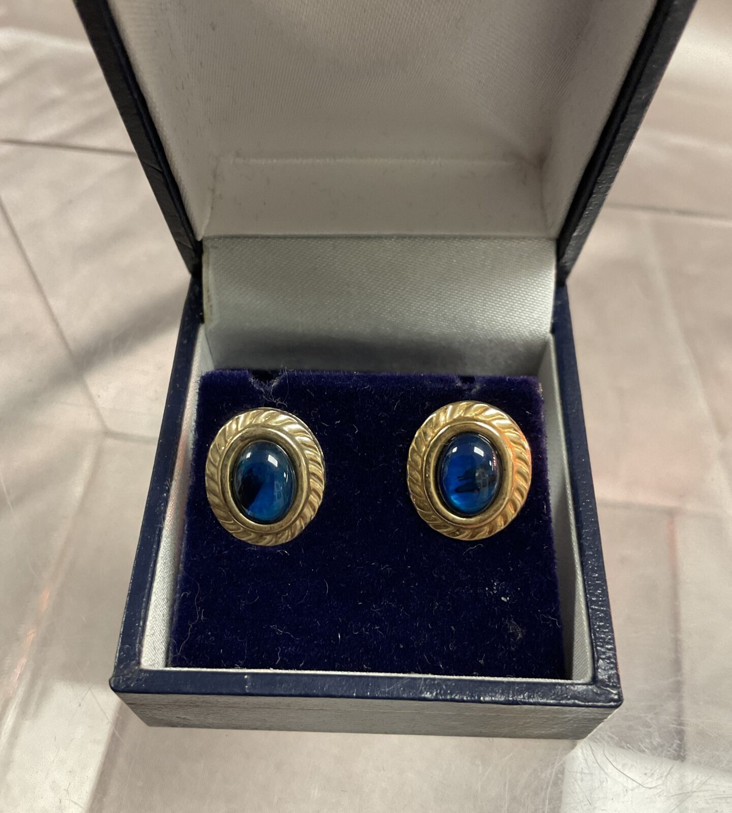 Pair of 9ct gold stud earrings set with blue stone