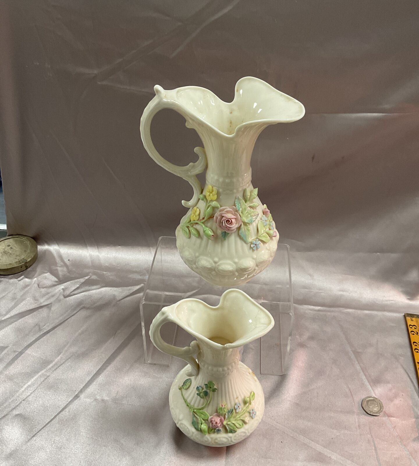 Two vintage Belleekaberdeen ewer pitchers with applied flowers smaller ewer repaired