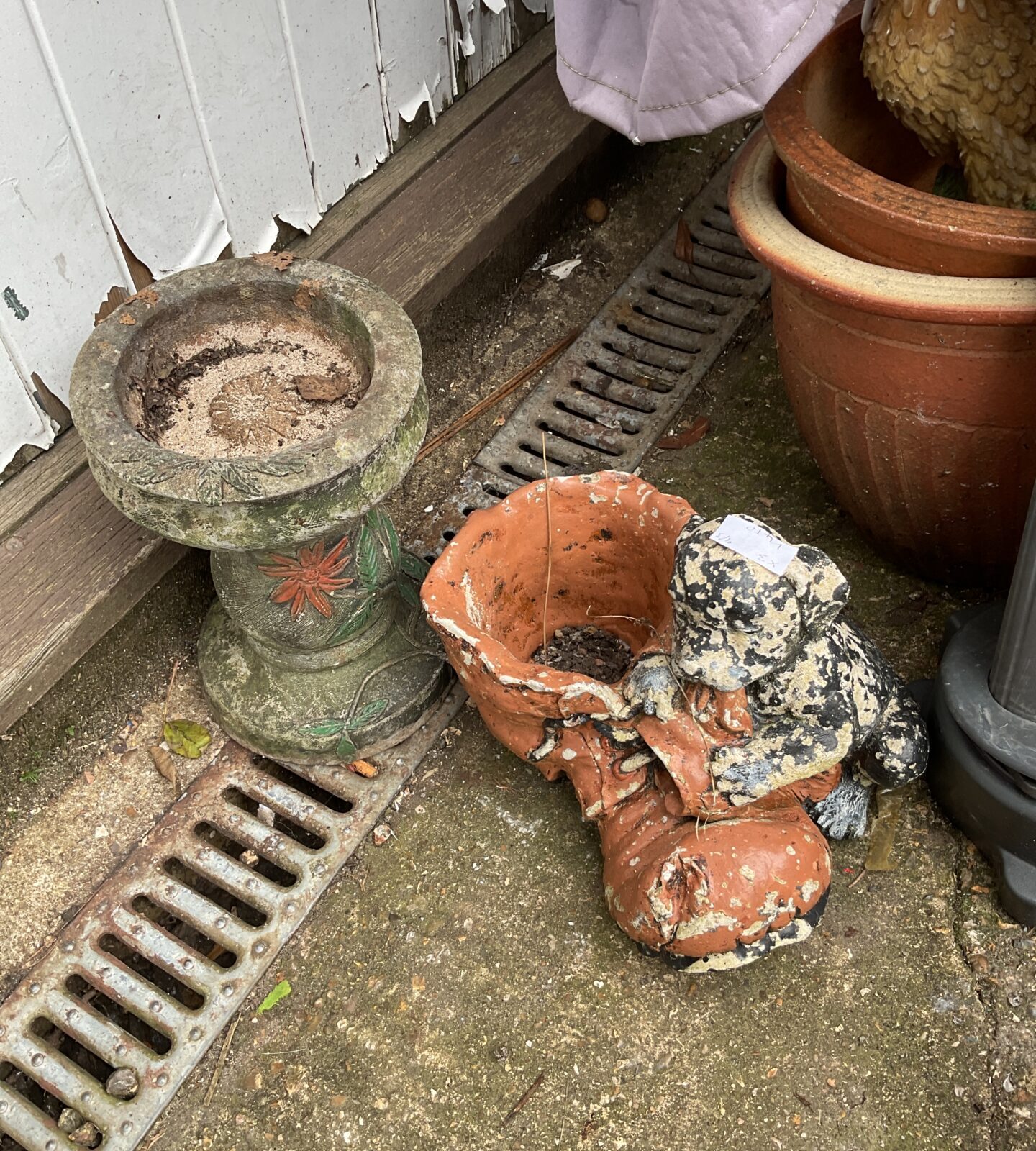 Two garden ornaments inc dog boot planter & small bird bath