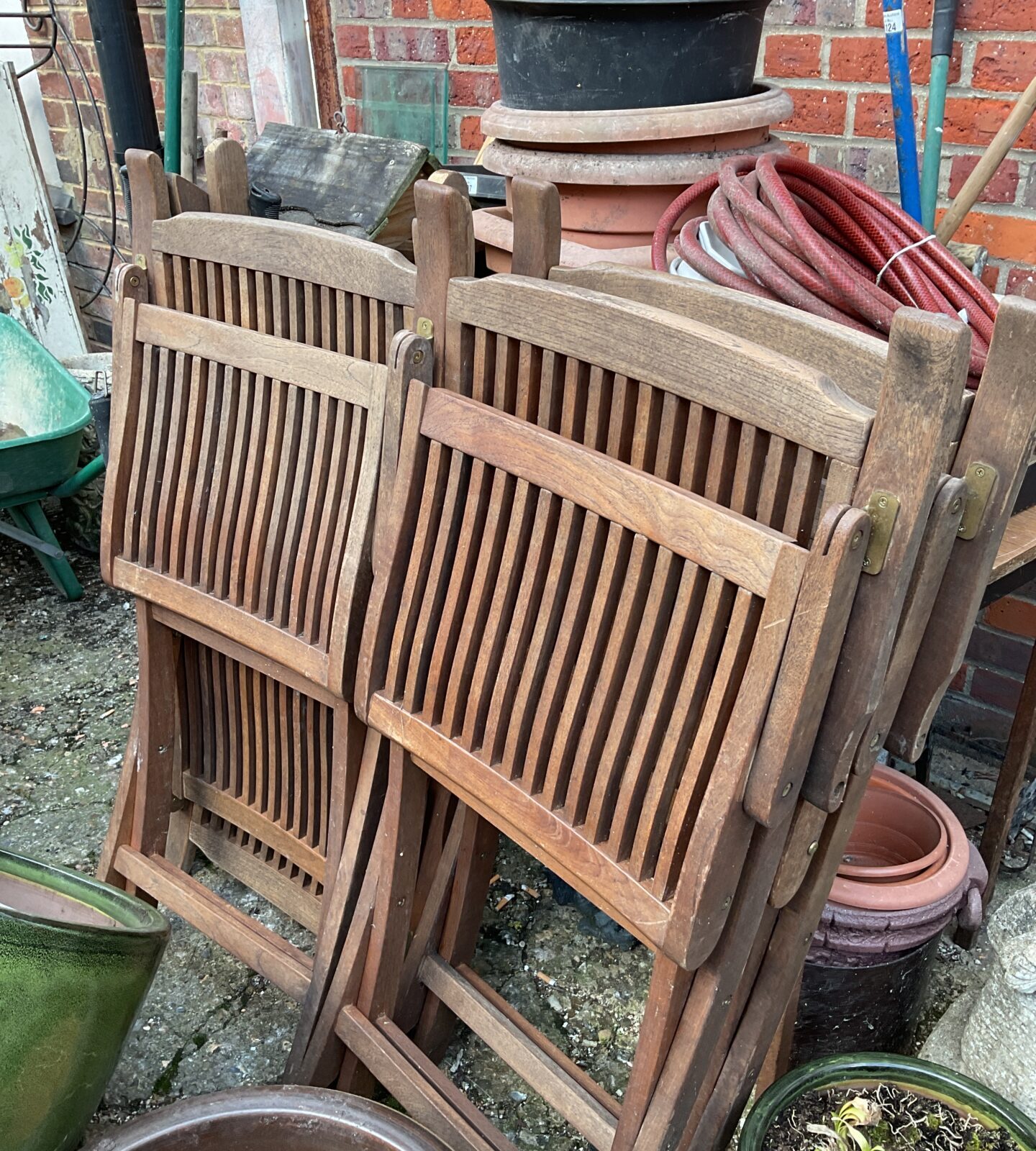 Four folding teak garden chairs