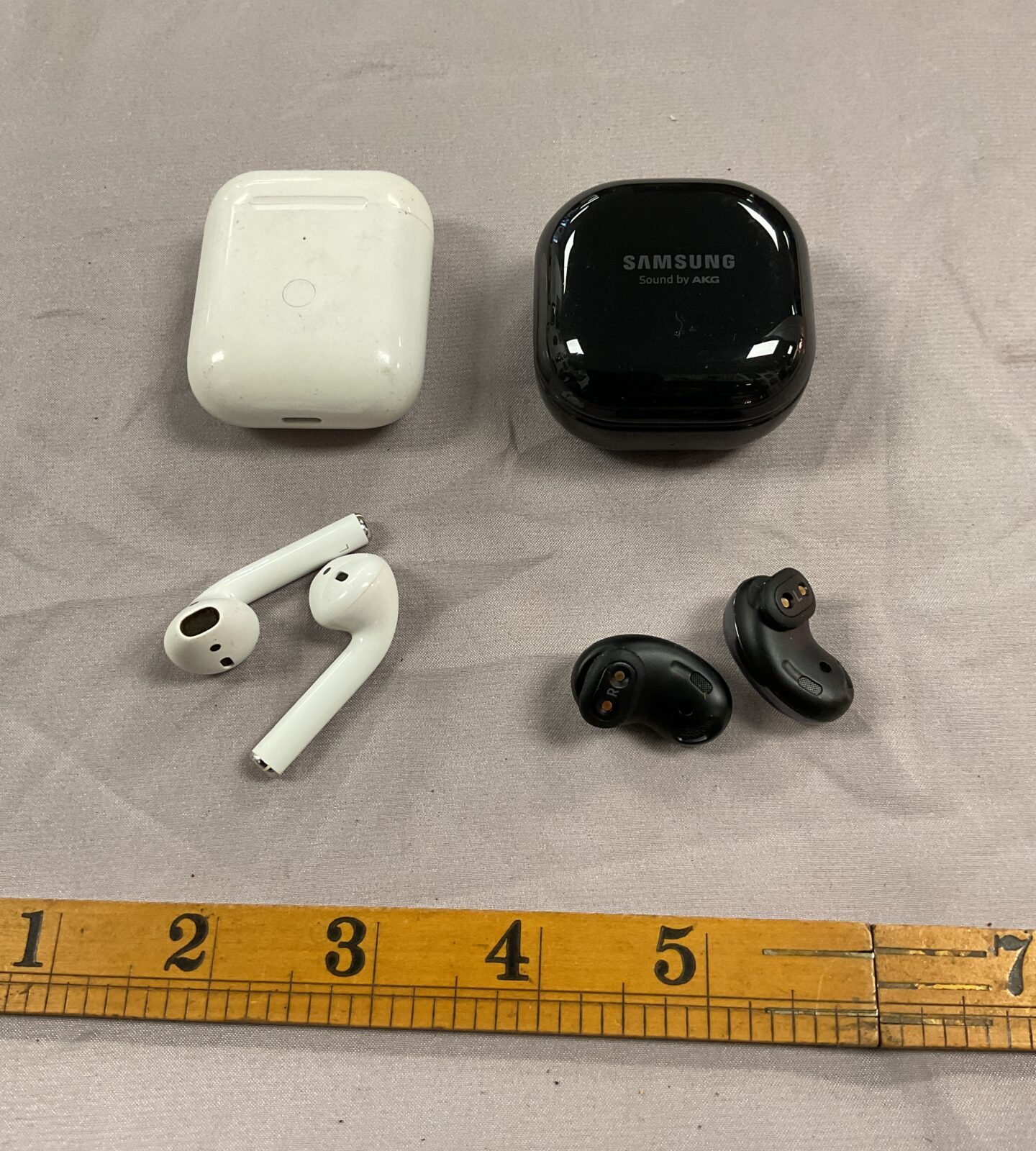 Pair of apple AirPods and pair of Samsung wireless earbuds