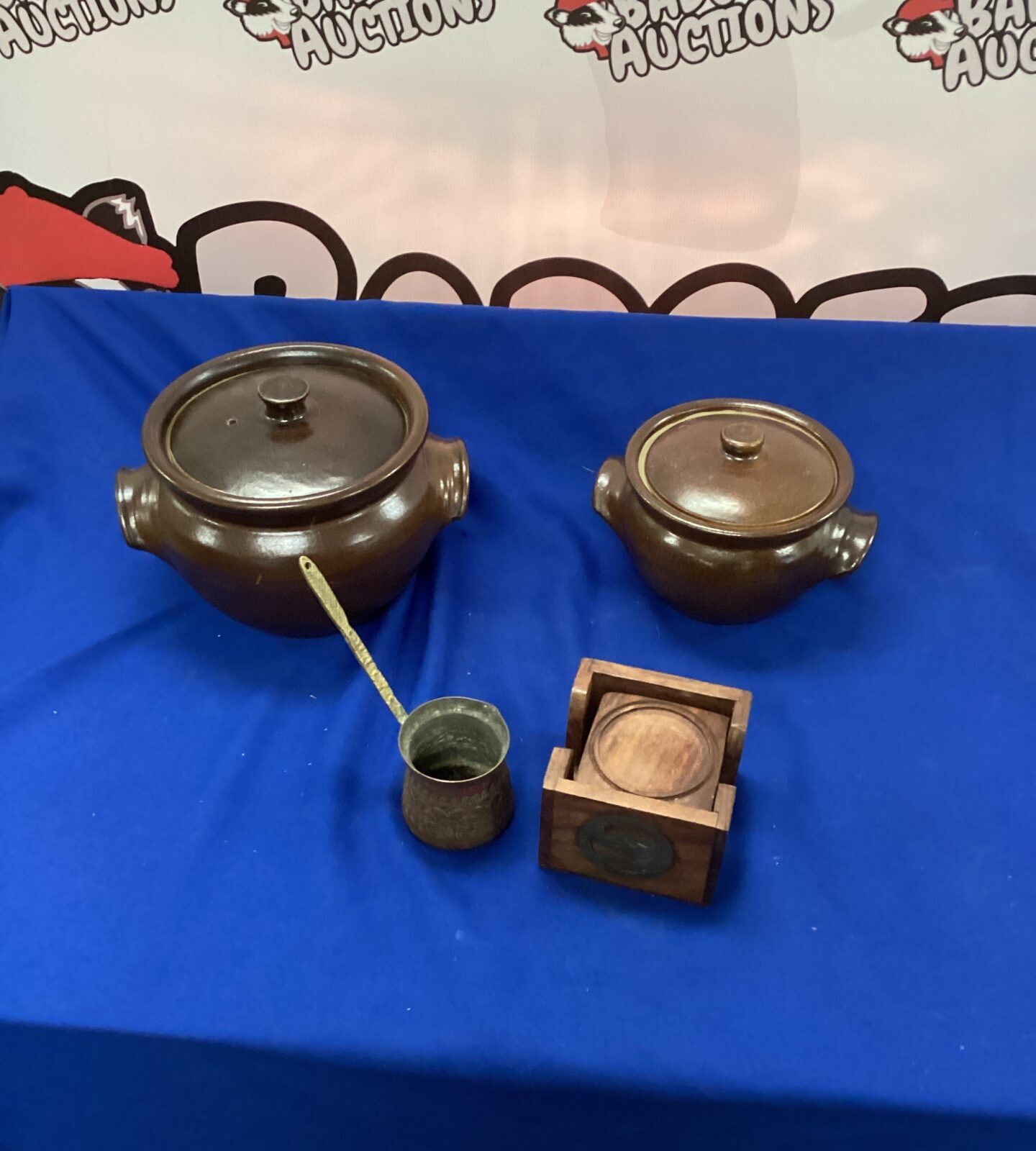 Moria Earthenware Casserole Dishes, brass ladle and coasters