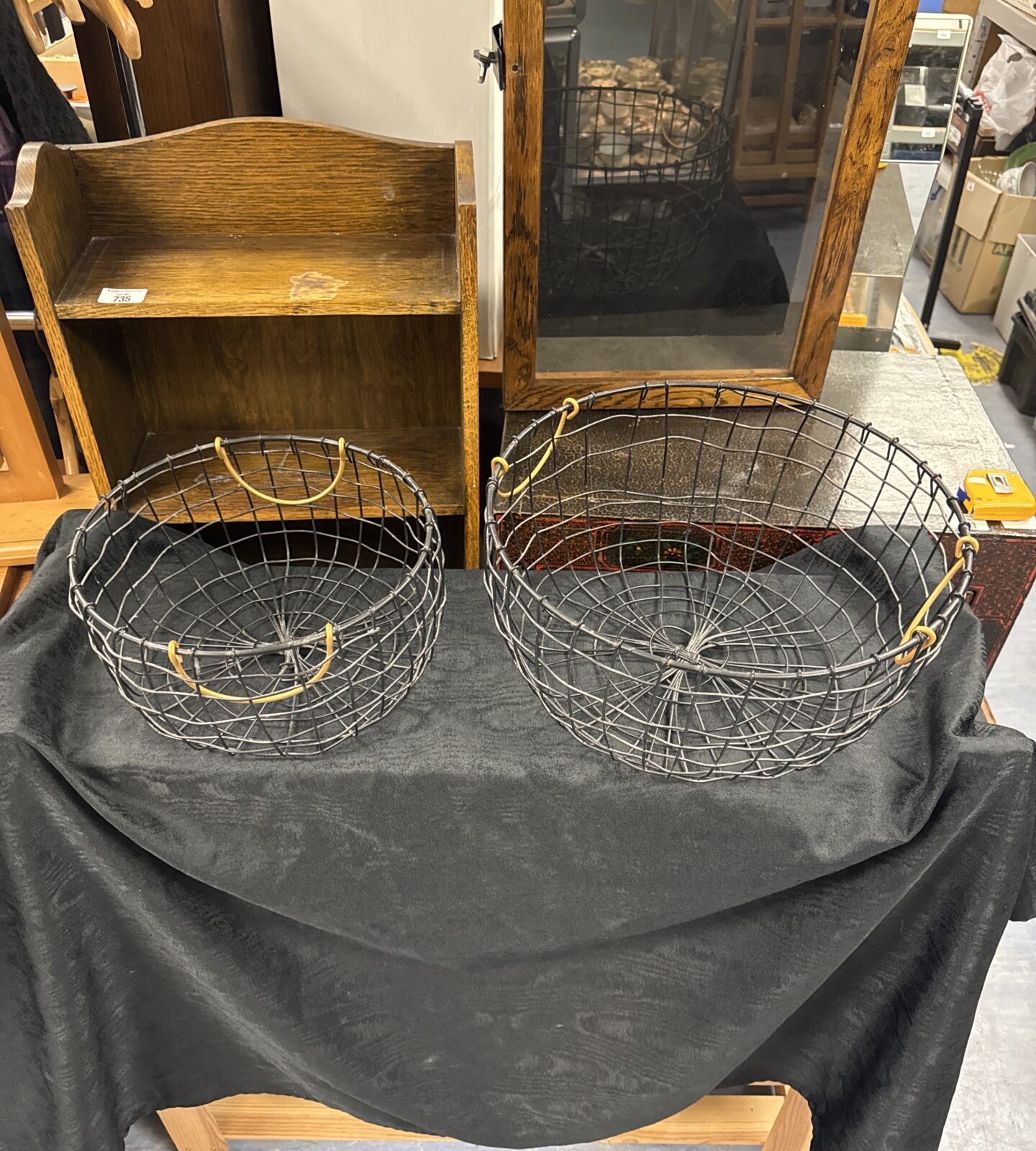 Two wire framed baskets with handles - larger one 14” diameter