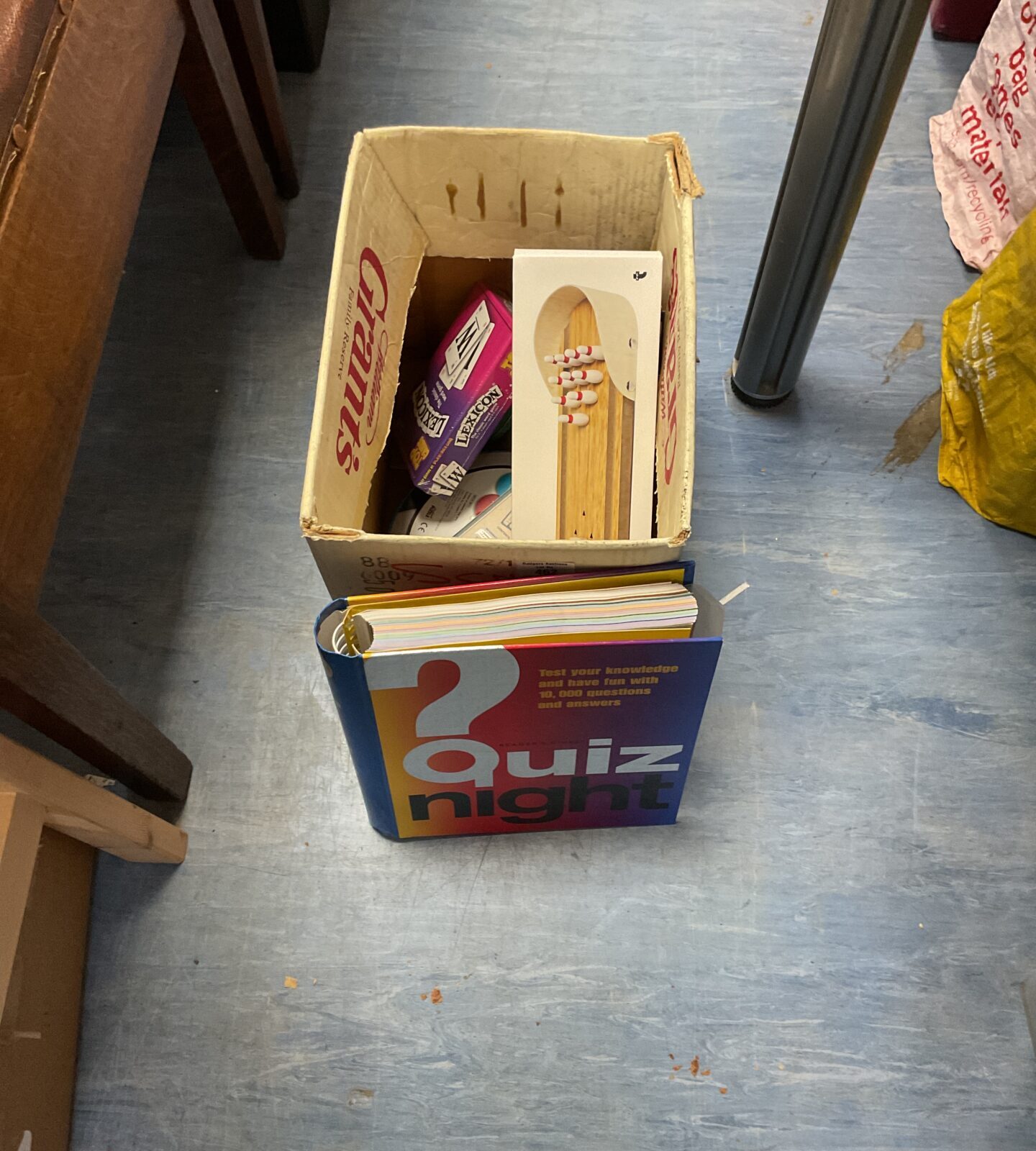 Box of mixed board games and quiz night book