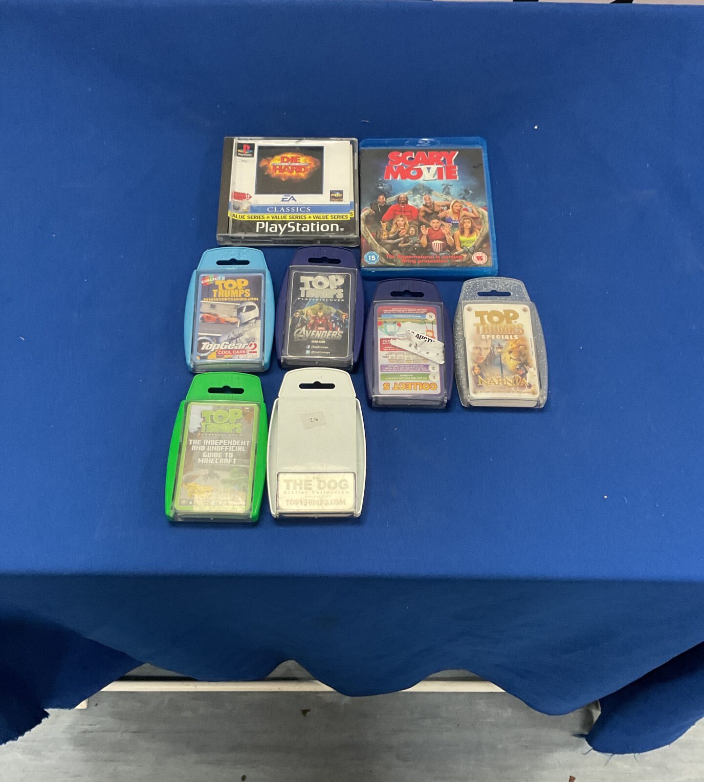 Box of Top trumps, scary movie dvd and PlayStation 1 game