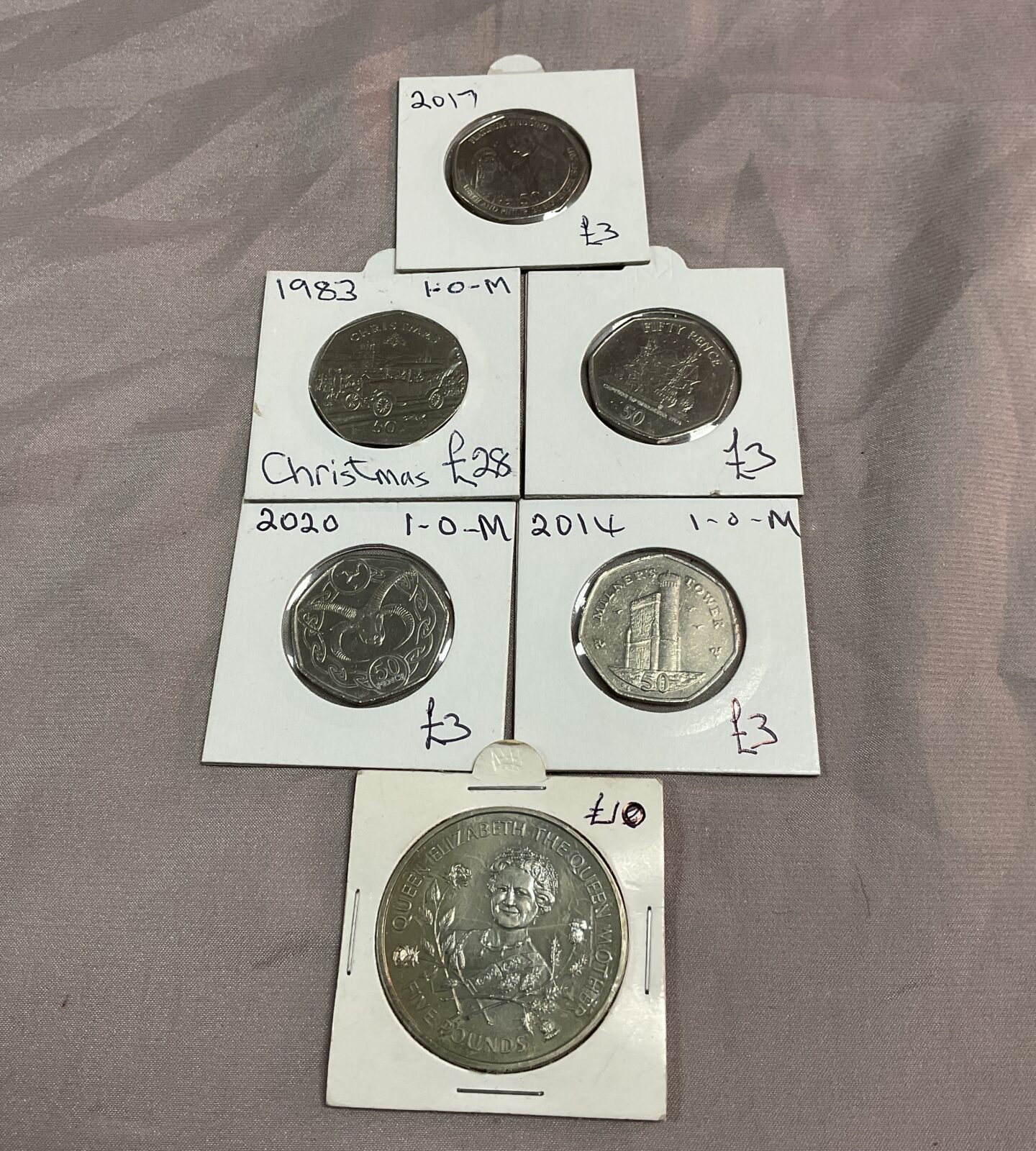 five IOM 50p commemoratve coins and £5 Guernsey coin