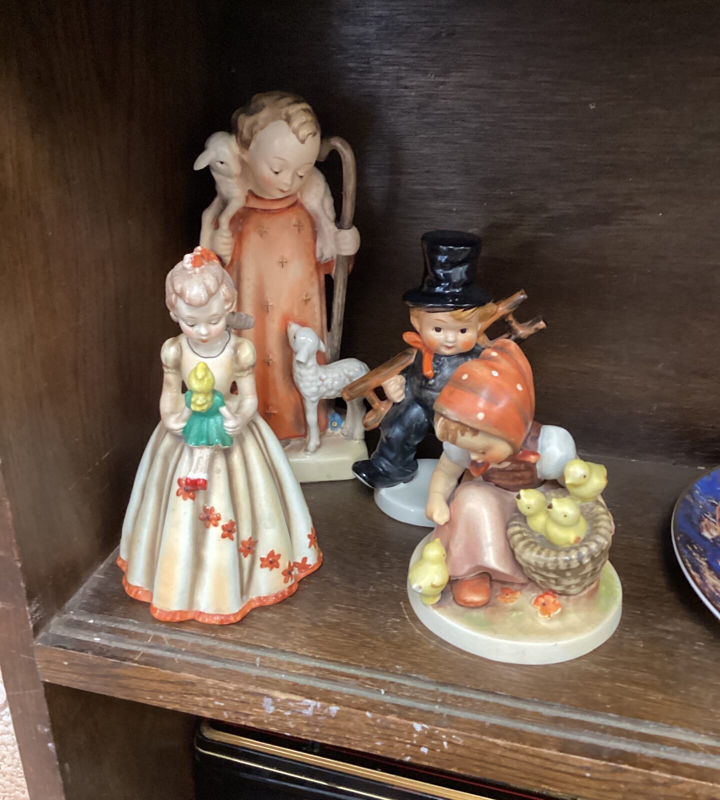 Four vintage hummel and Goebel figures