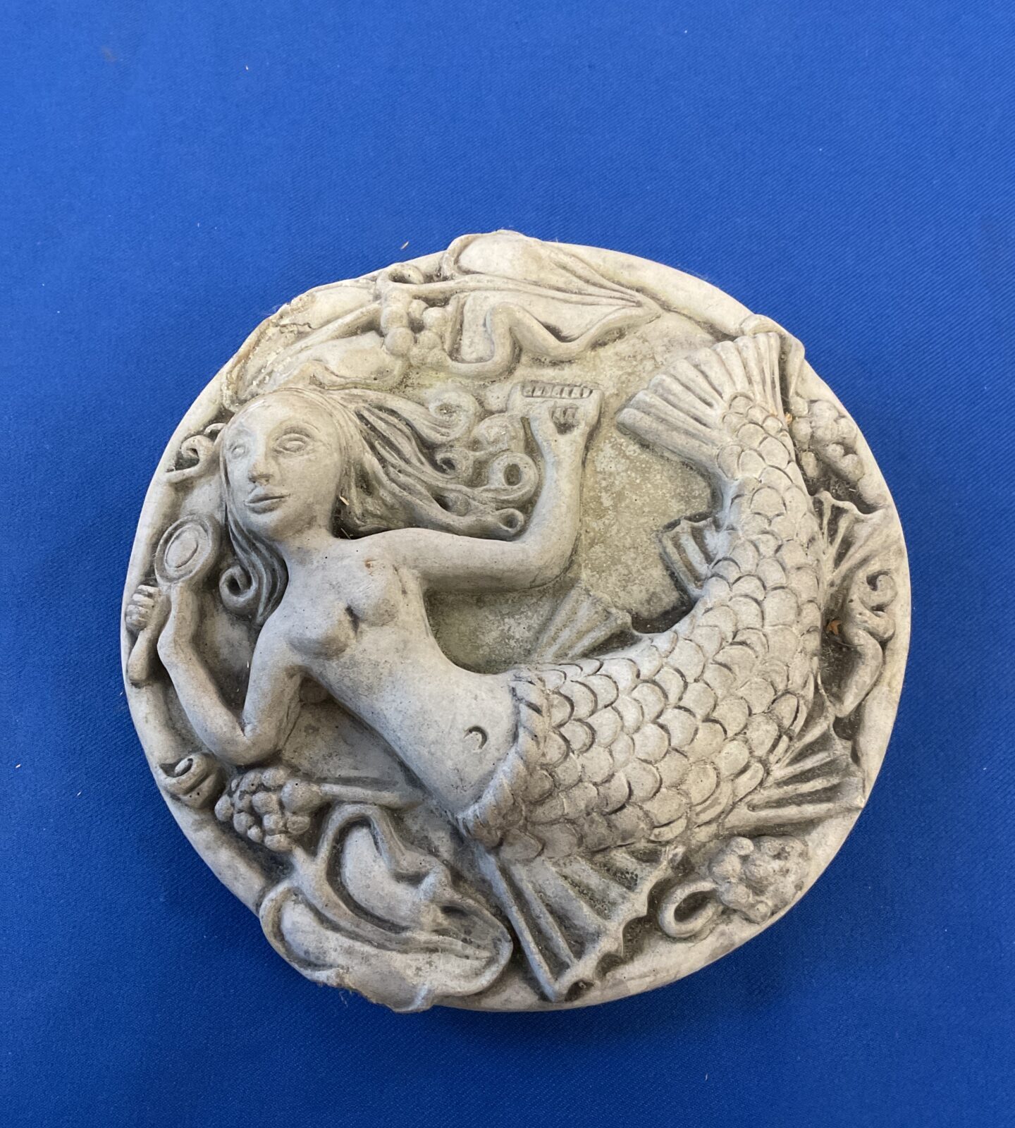 Cast stone wall plaque of a mermaid