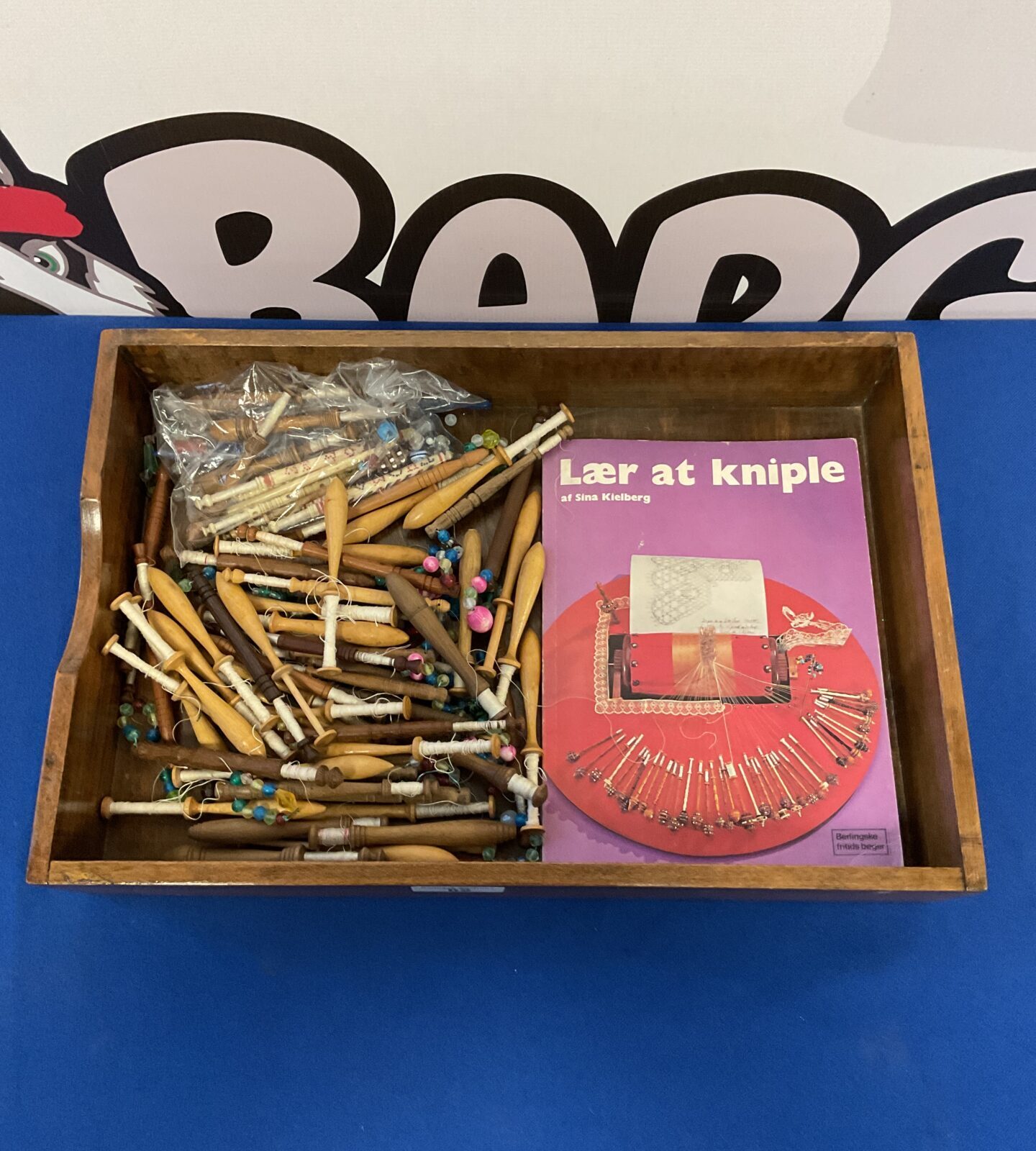 Collection of lace bobbins with book