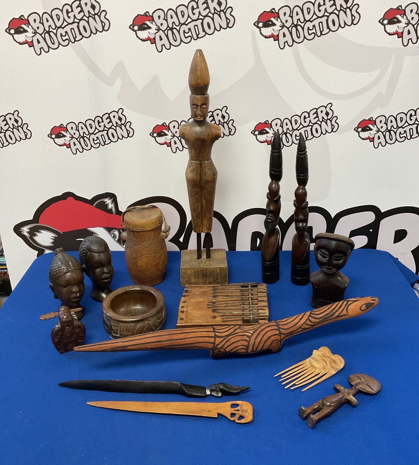 Collection of carved African hardwood items including busts & comb