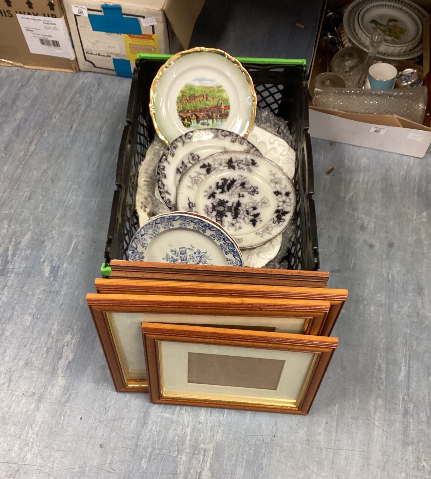 Box of collectible plates and new picture frames