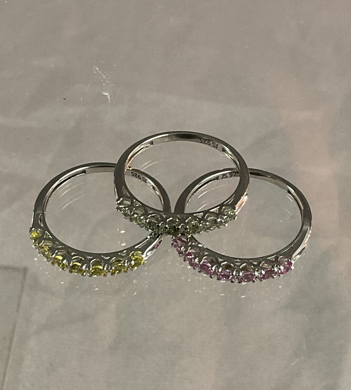 Three silver rings with coloured stones Sizes N/O