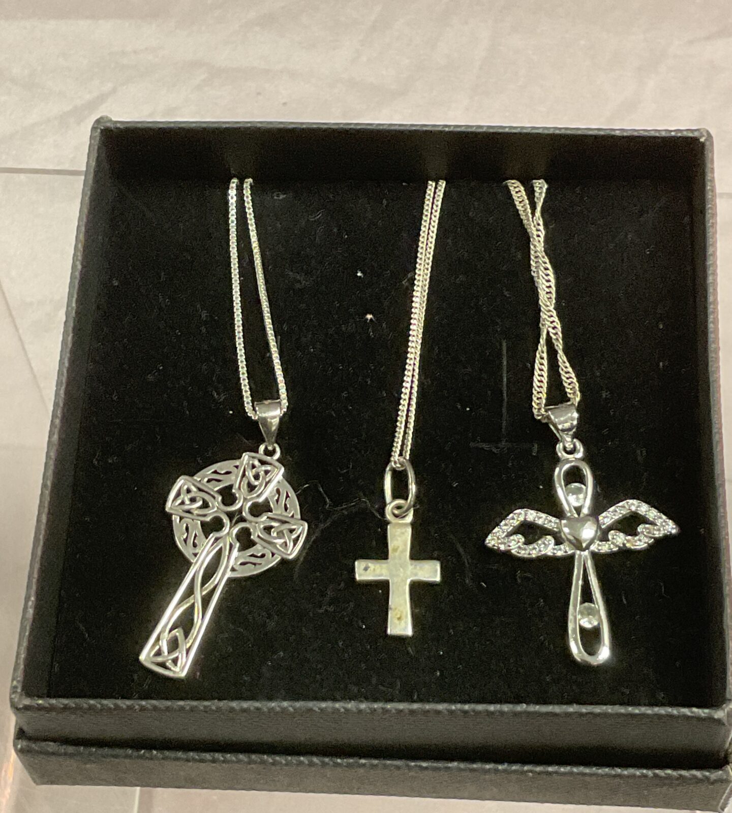 Three silver cross pendant necklaces