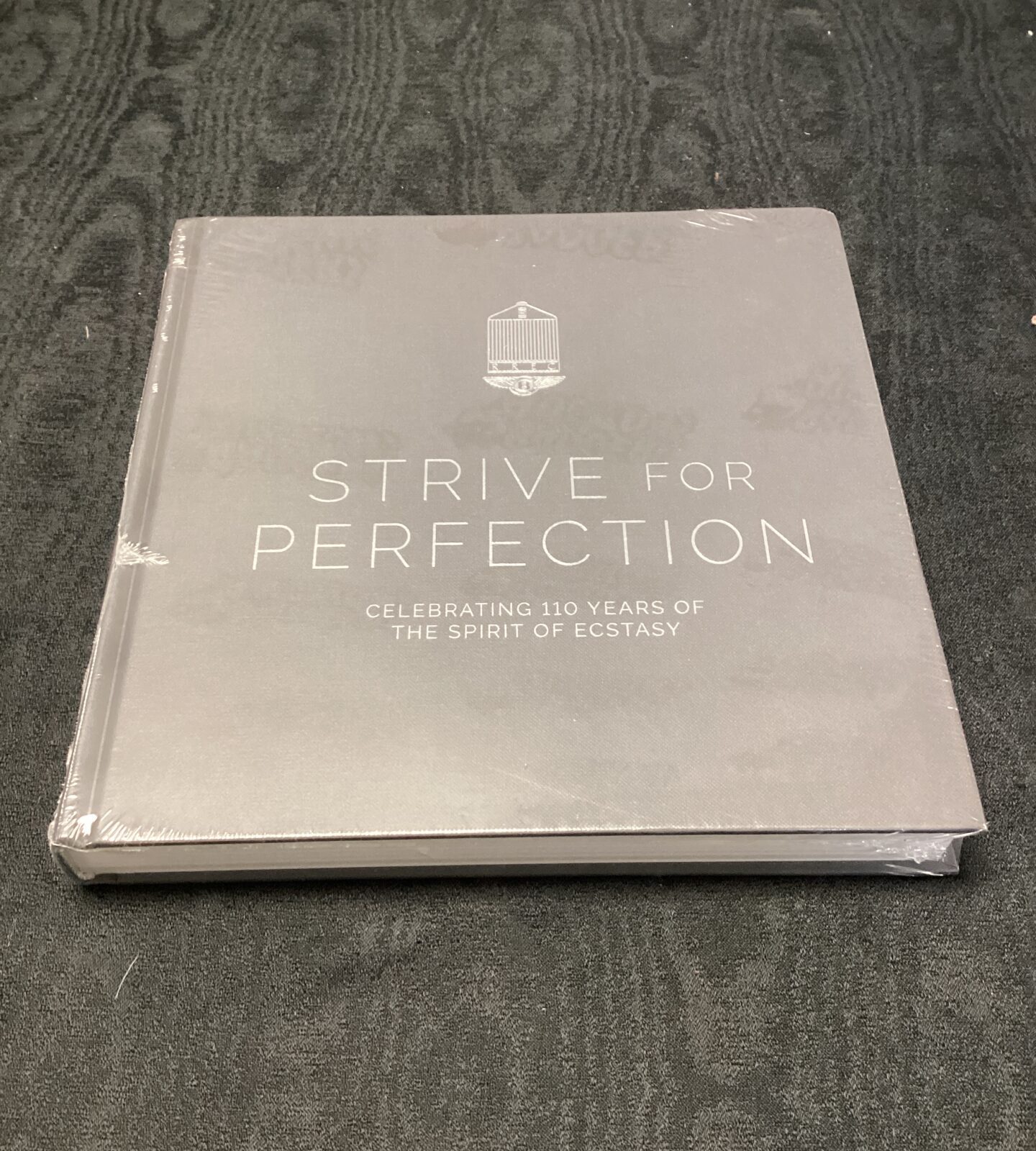 New sealed strive for perfection Rolls-Royce book celebrating 110 years of the spirit of ecstasy