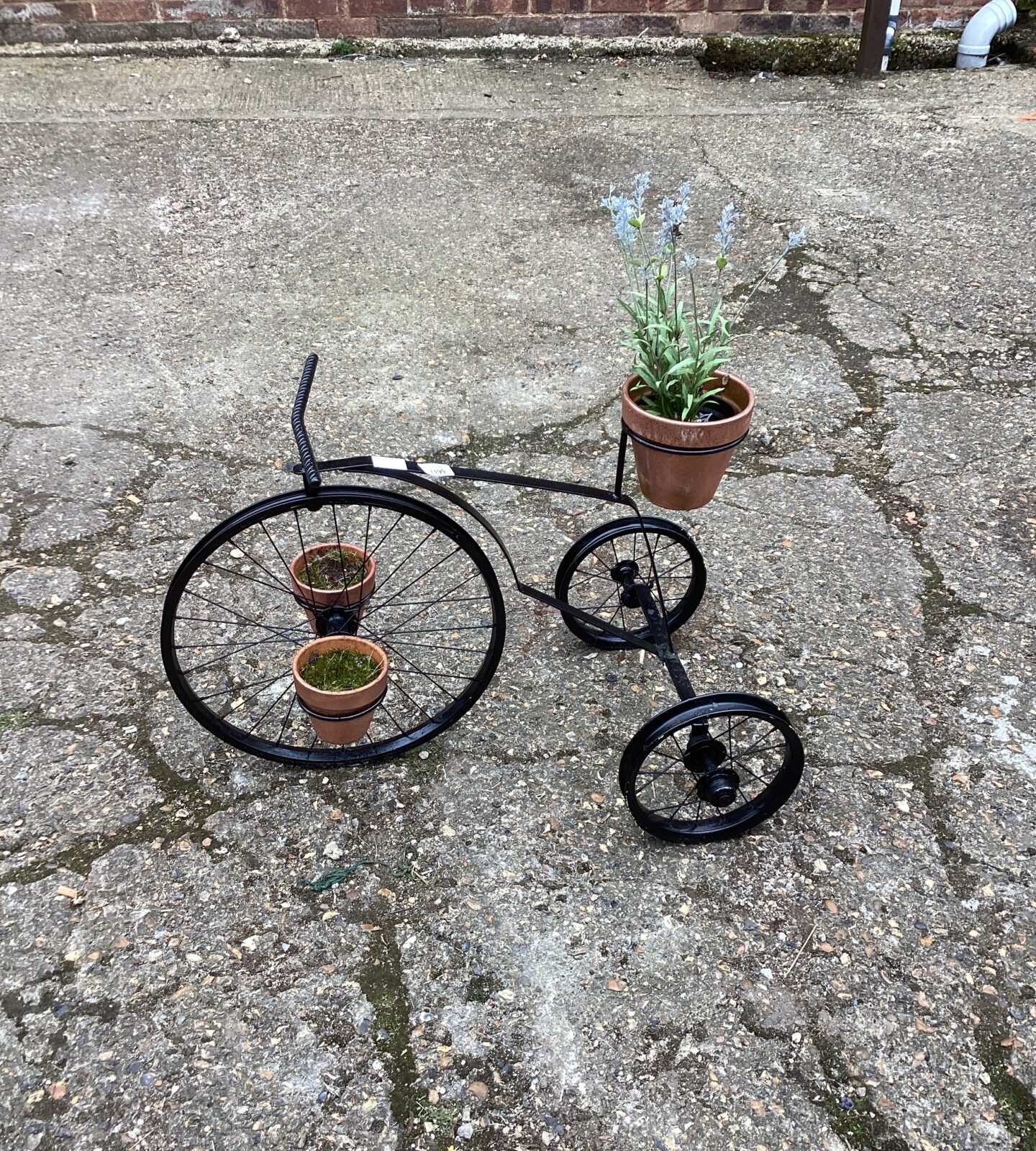 Black metal bike plant pot holder